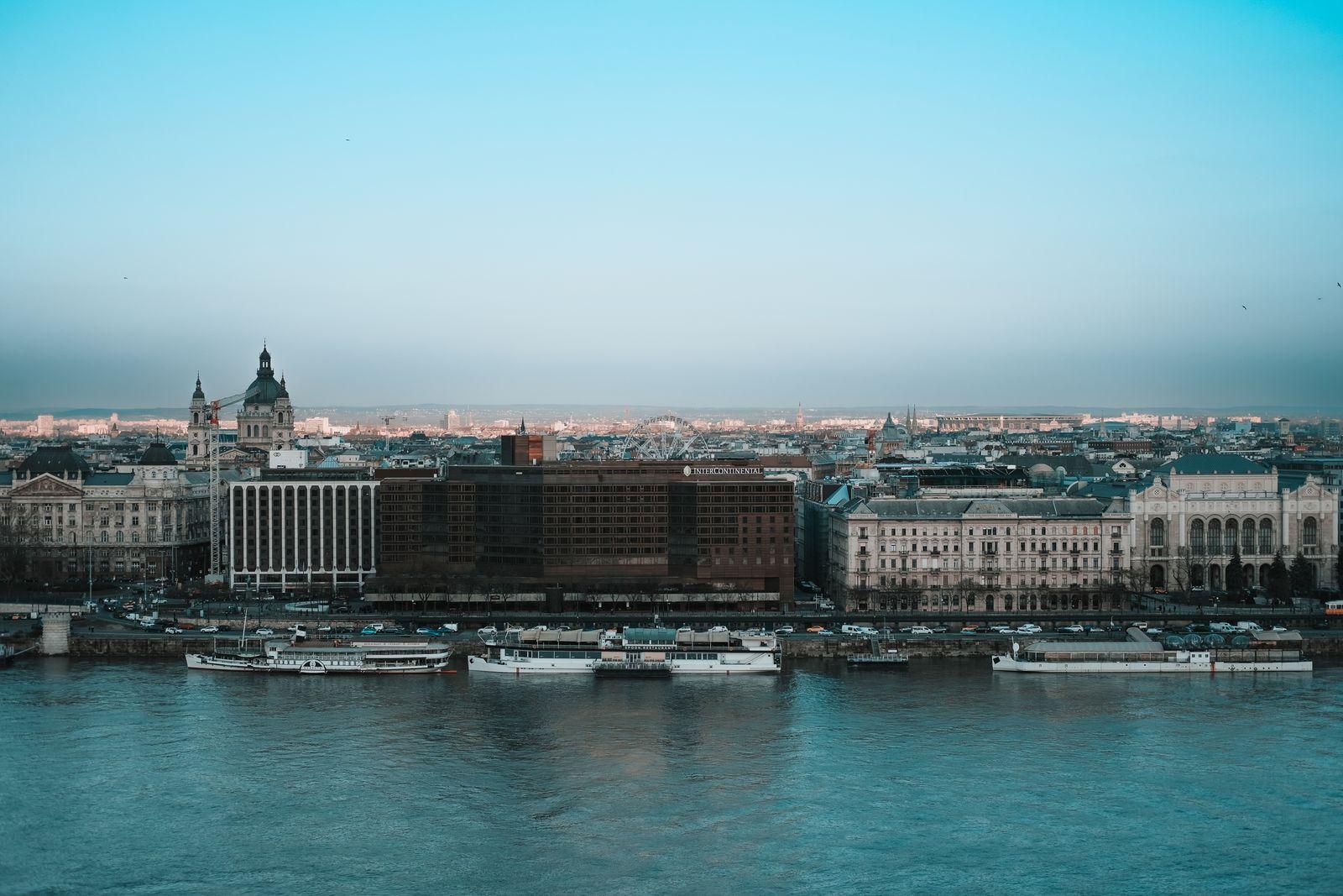 The Pest embankment along the Danube at dusk, St Stephen’s dome behind
