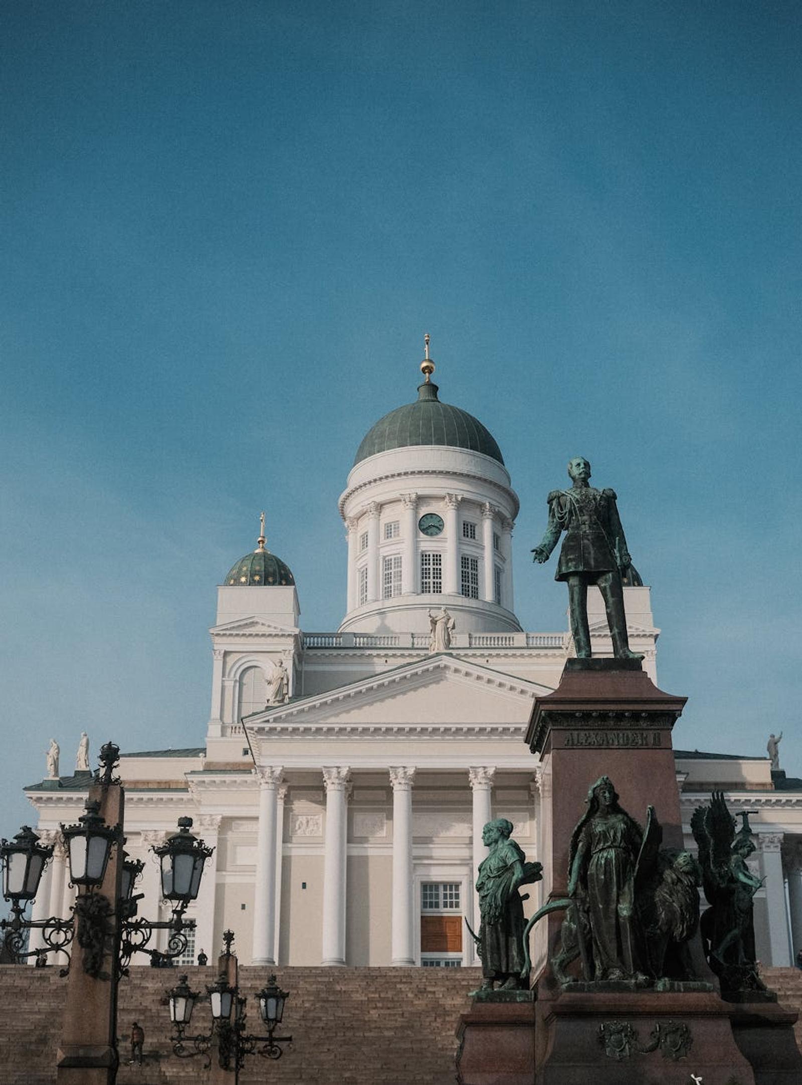 Helsinki Cathedral and Alexander II statue under clear blue skies