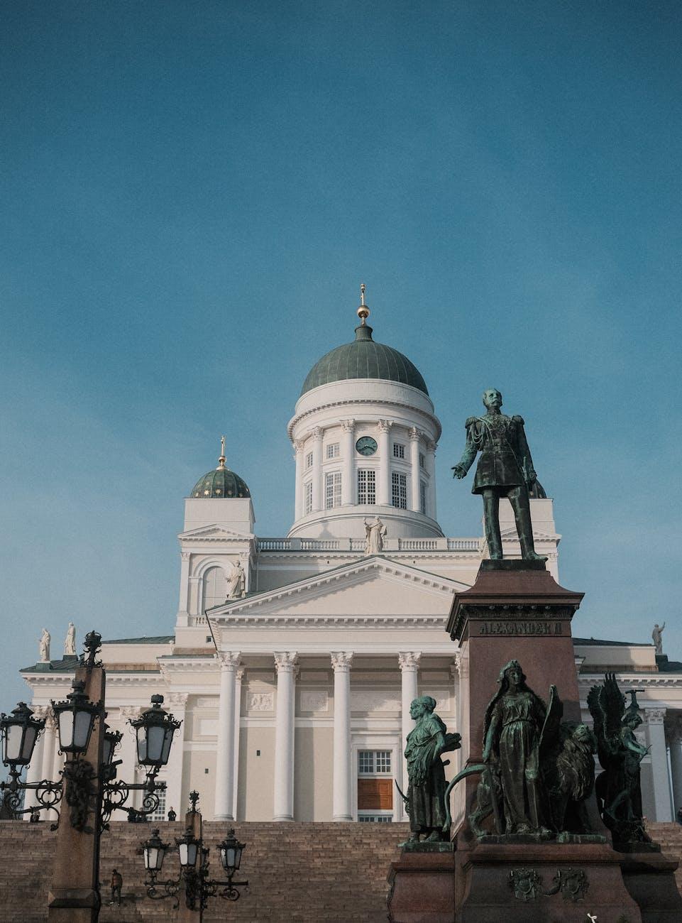 Helsinki Cathedral and Alexander II statue under clear blue skies