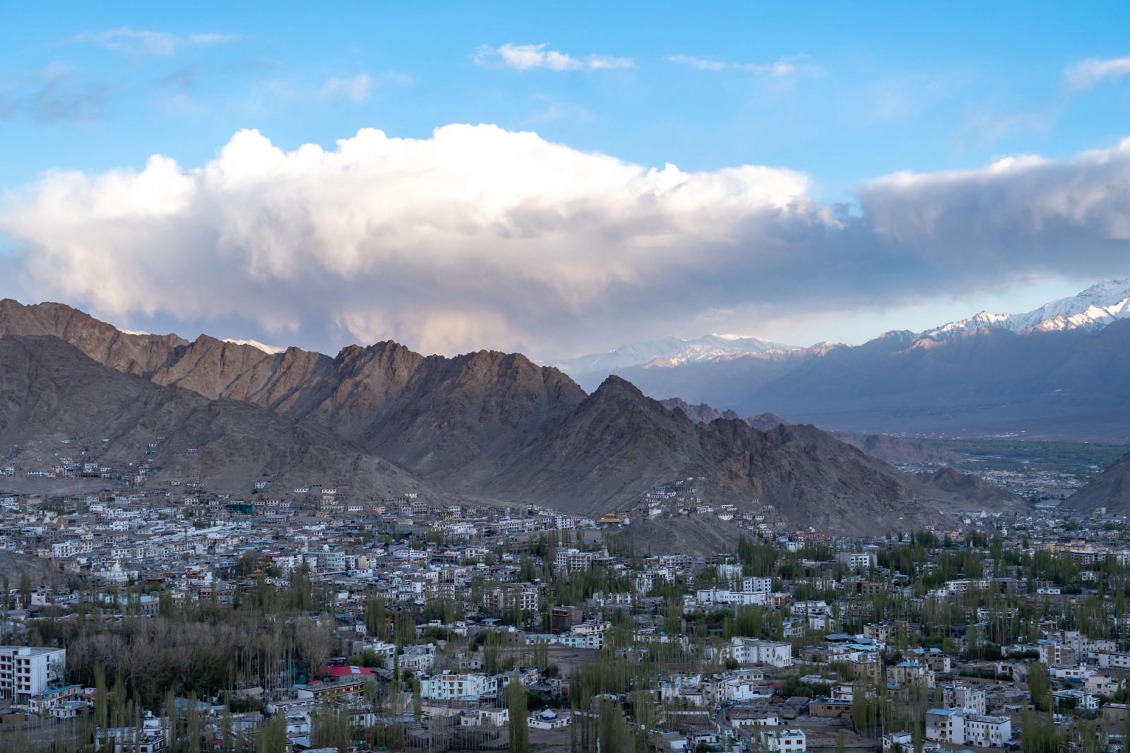 Breathtaking view of Leh town surrounded by towering mountains and clear blue skies