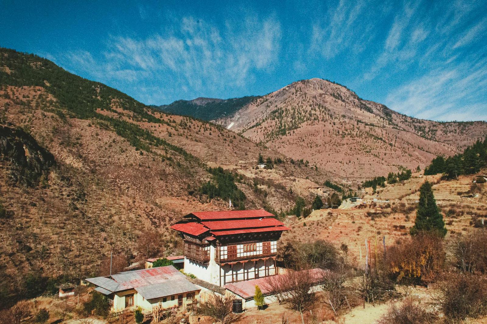 Idyllic traditional house nestled in a scenic mountain valley during summer with clear skies