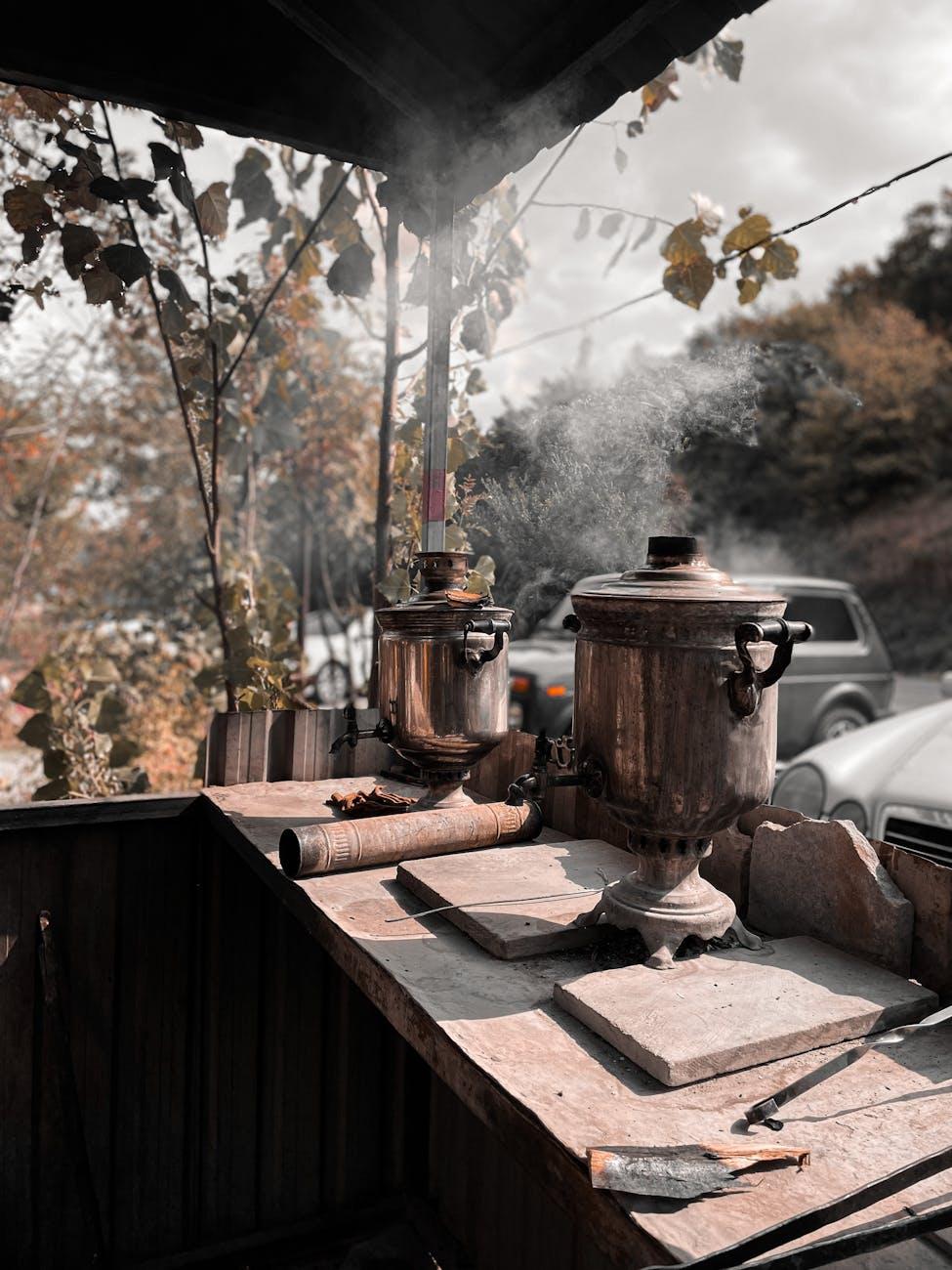 Rustic samovars steaming in an outdoor autumn setting in Azerbaijan