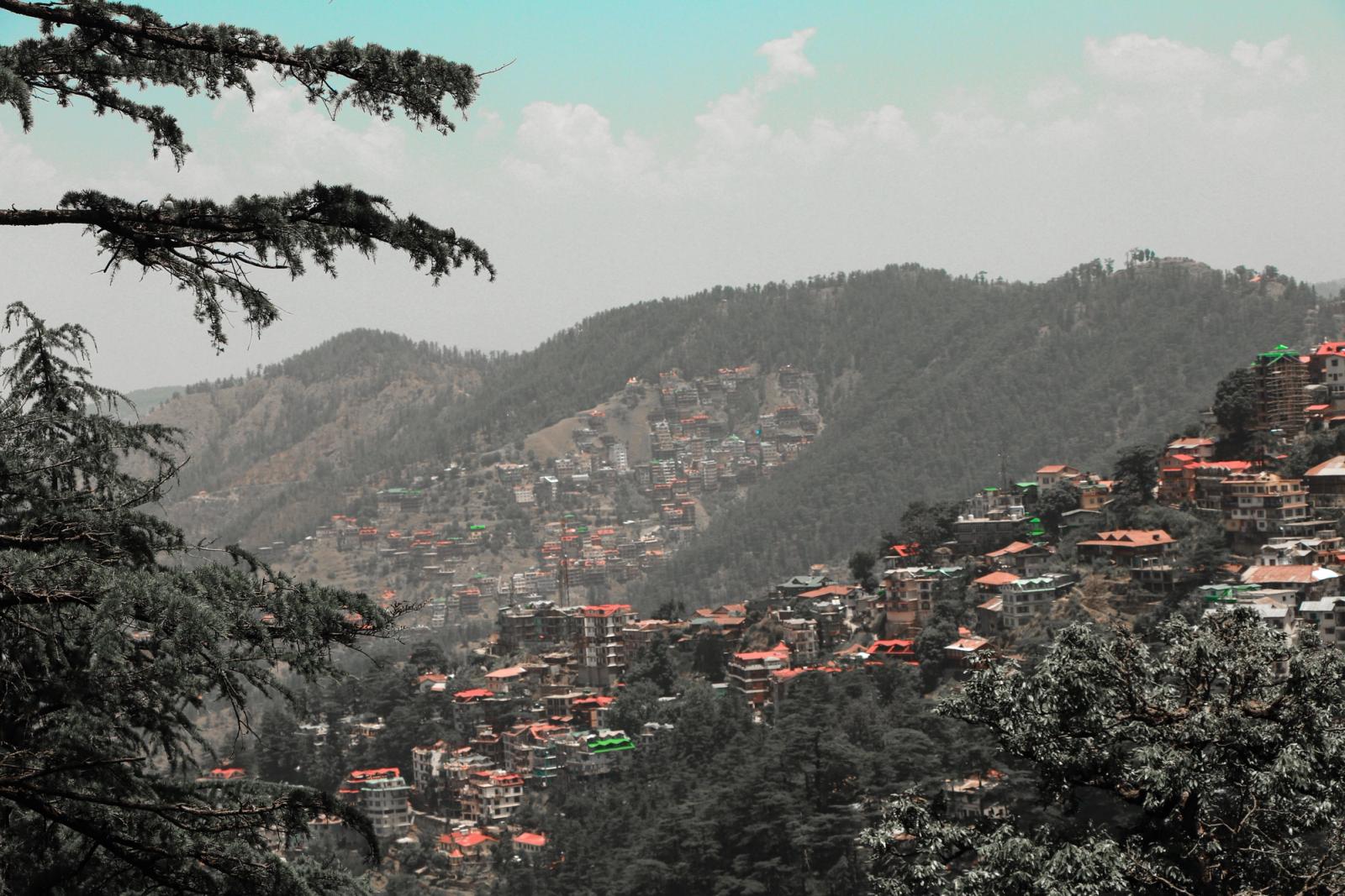 Capture of Shimla's vibrant landscape with hills and dense buildings