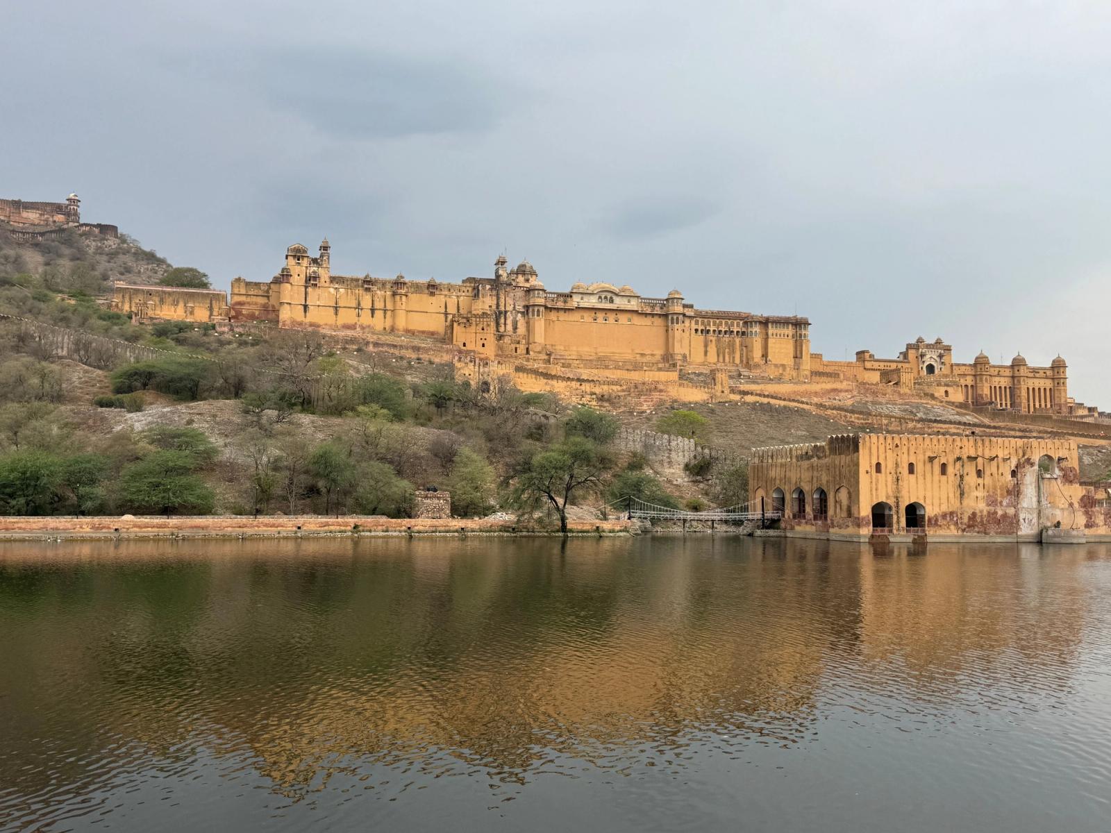 Stunning view of Amber Fort reflecting on the Maota Lake in Jaipur, showcasing historical architecture