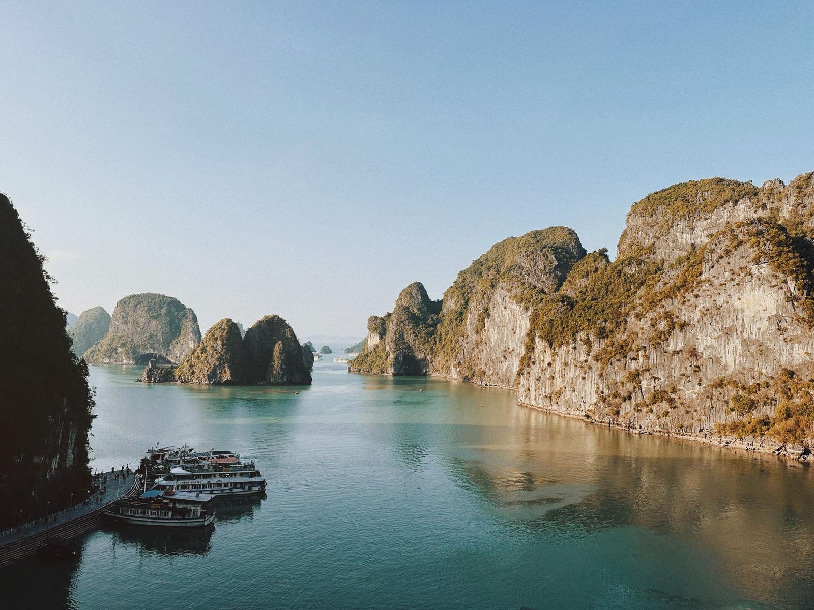 A breathtaking view of Halong Bay's limestone karsts and boats on serene waters