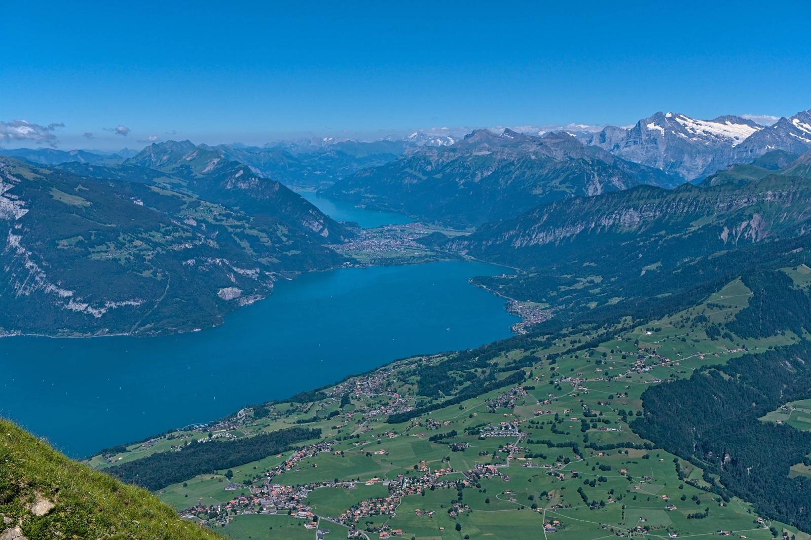 Stunning aerial view of Thun Lake and Swiss Alps, capturing lush valleys and majestic mountains