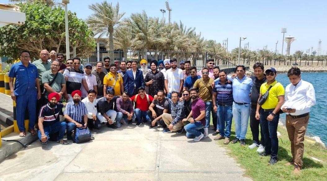 Group posing at the Bahrain-Saudi Arabia border crossing.