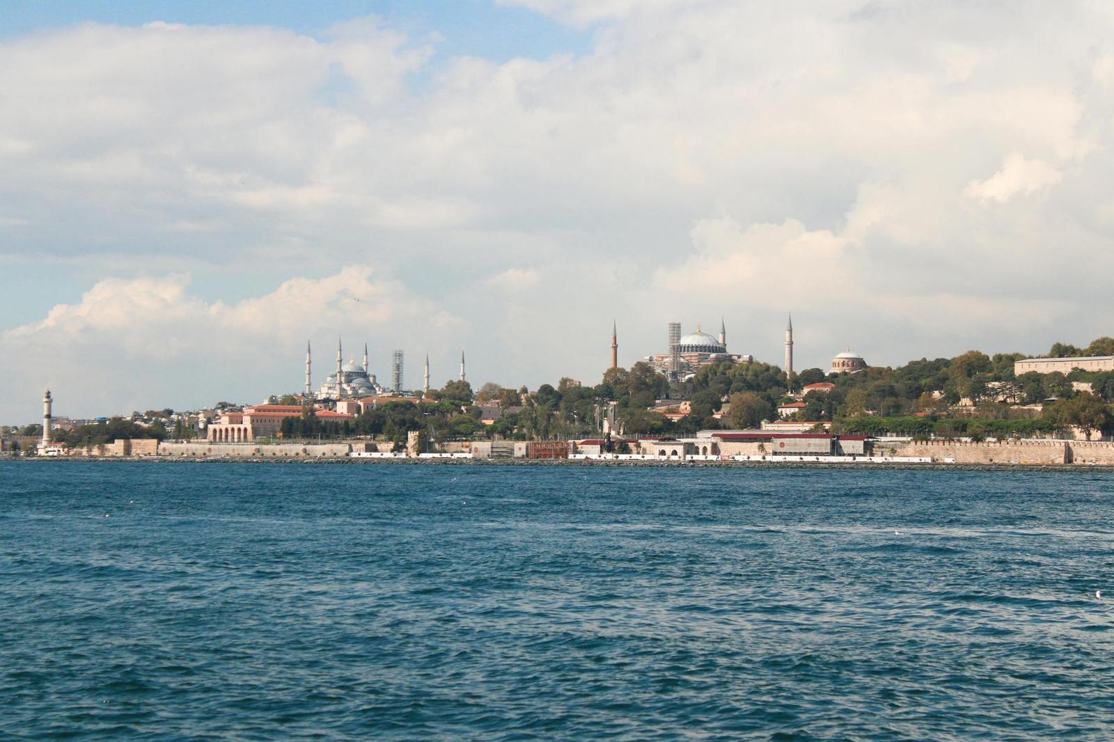 Waterfront skyline with domed mosques seen across the strait