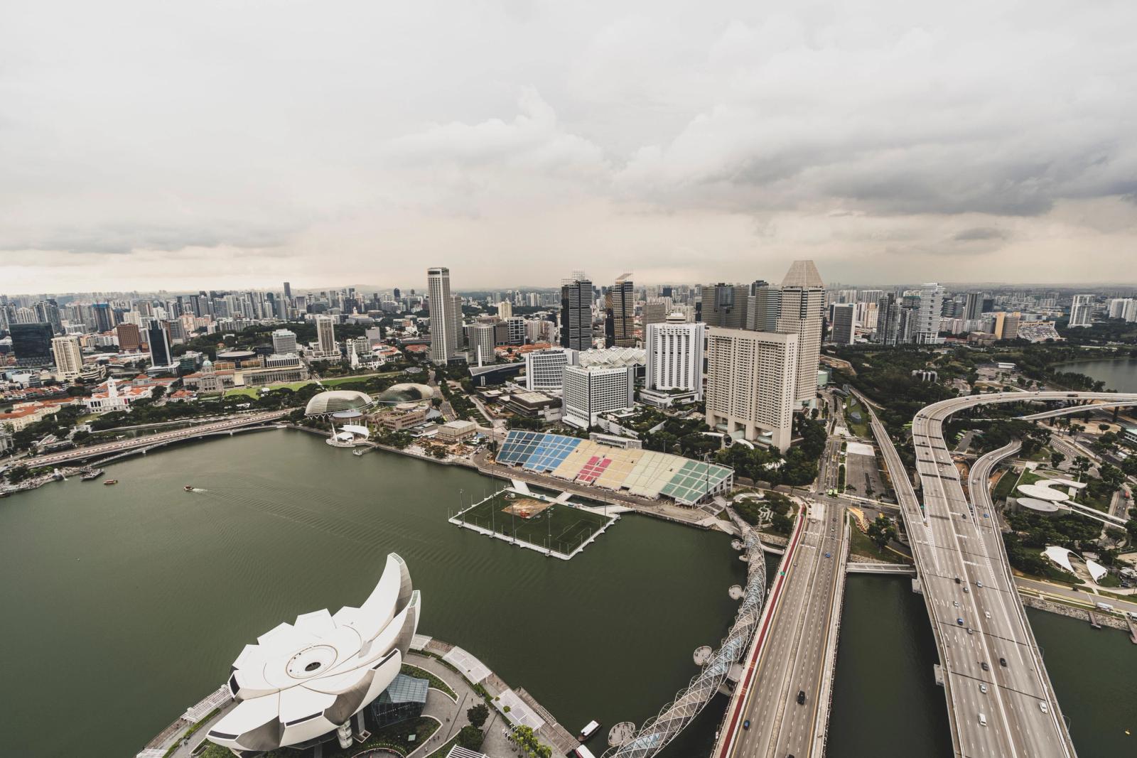 Explore the modern skyline of Singapore with the iconic Marina Bay in an aerial view capturing the city's architecture