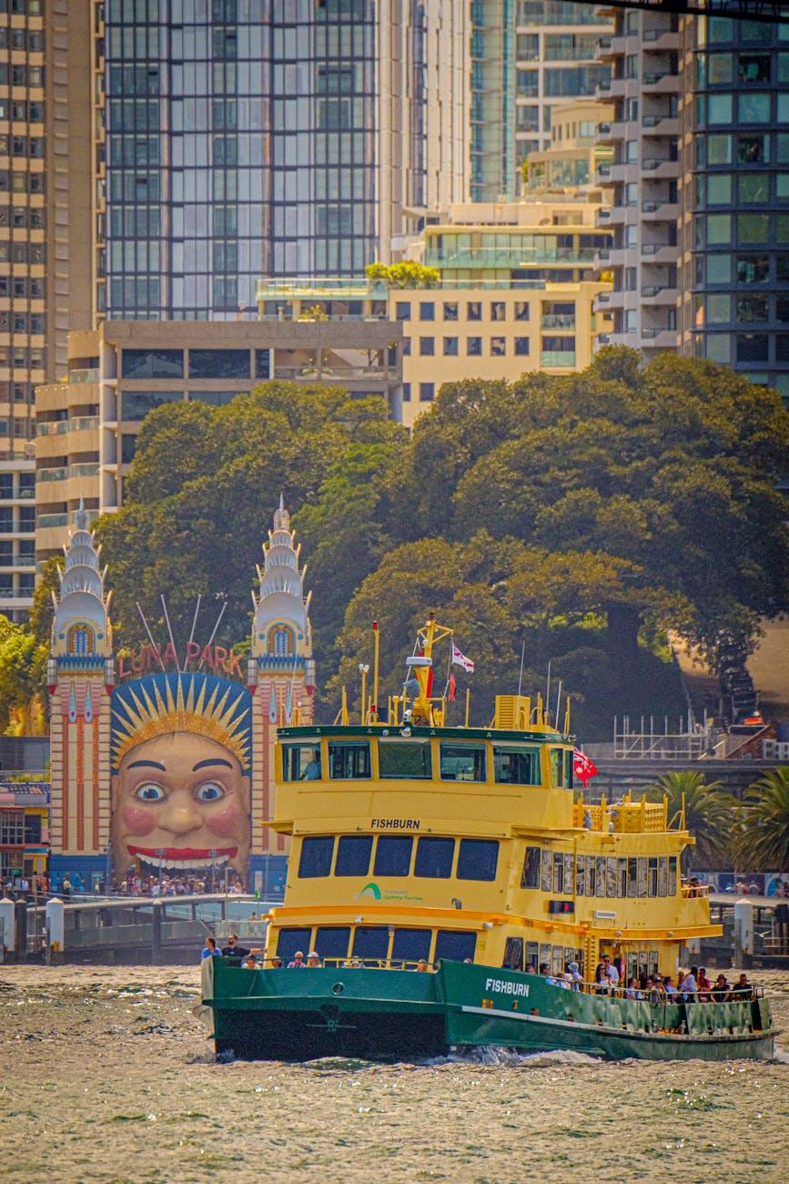 Ferry crossing Sydney Harbour with iconic Luna Park entrance in background