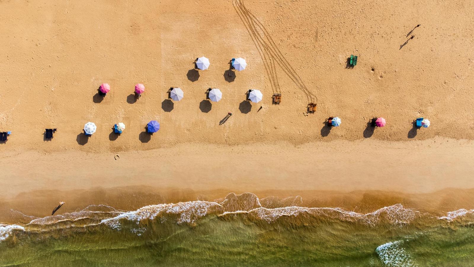 Top view of beach with colorful umbrellas in Bentota, Sri Lanka