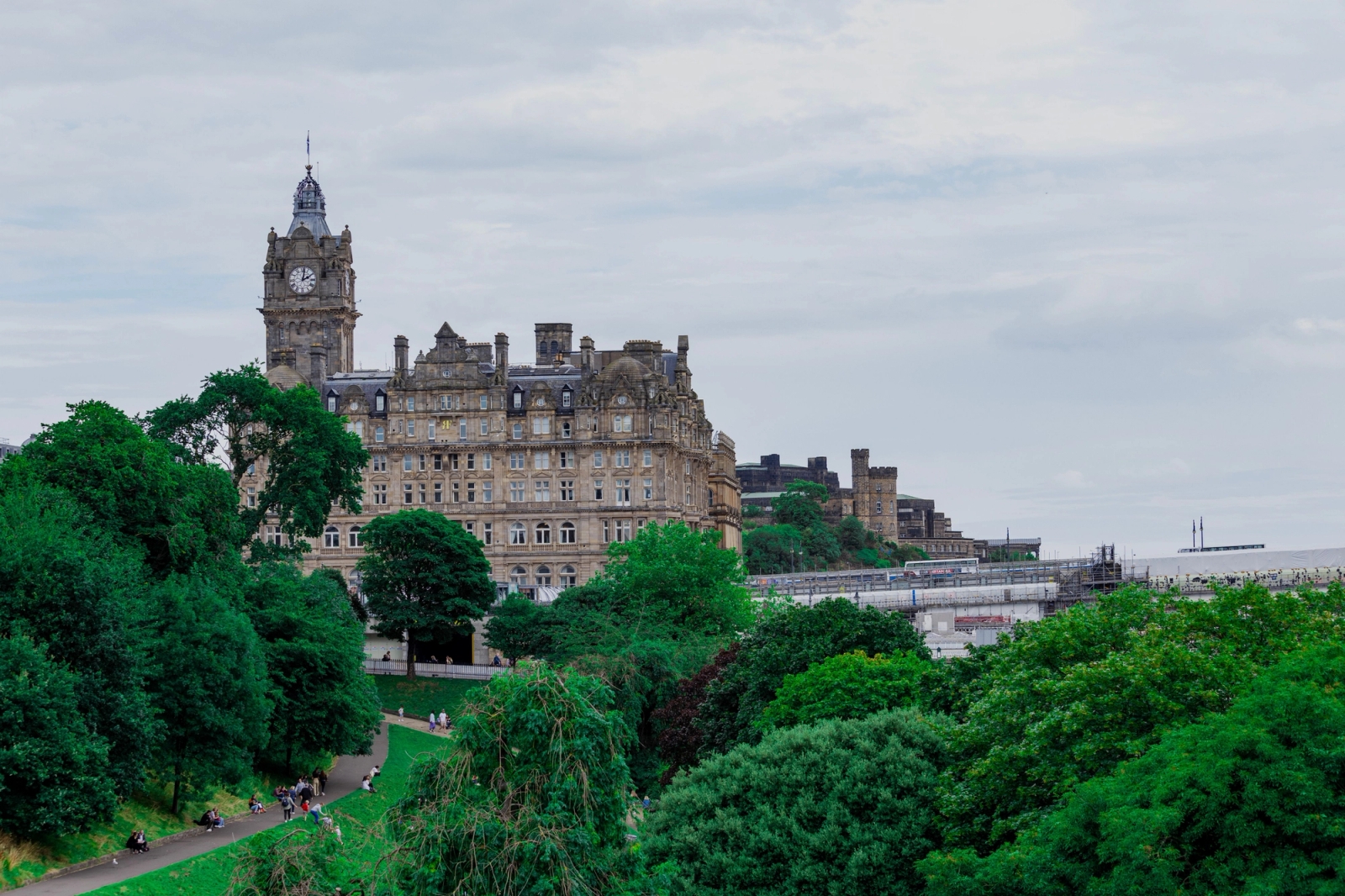 Stunning view of the Victorian Balmoral Hotel amidst lush greenery in Edinburgh, Scotland