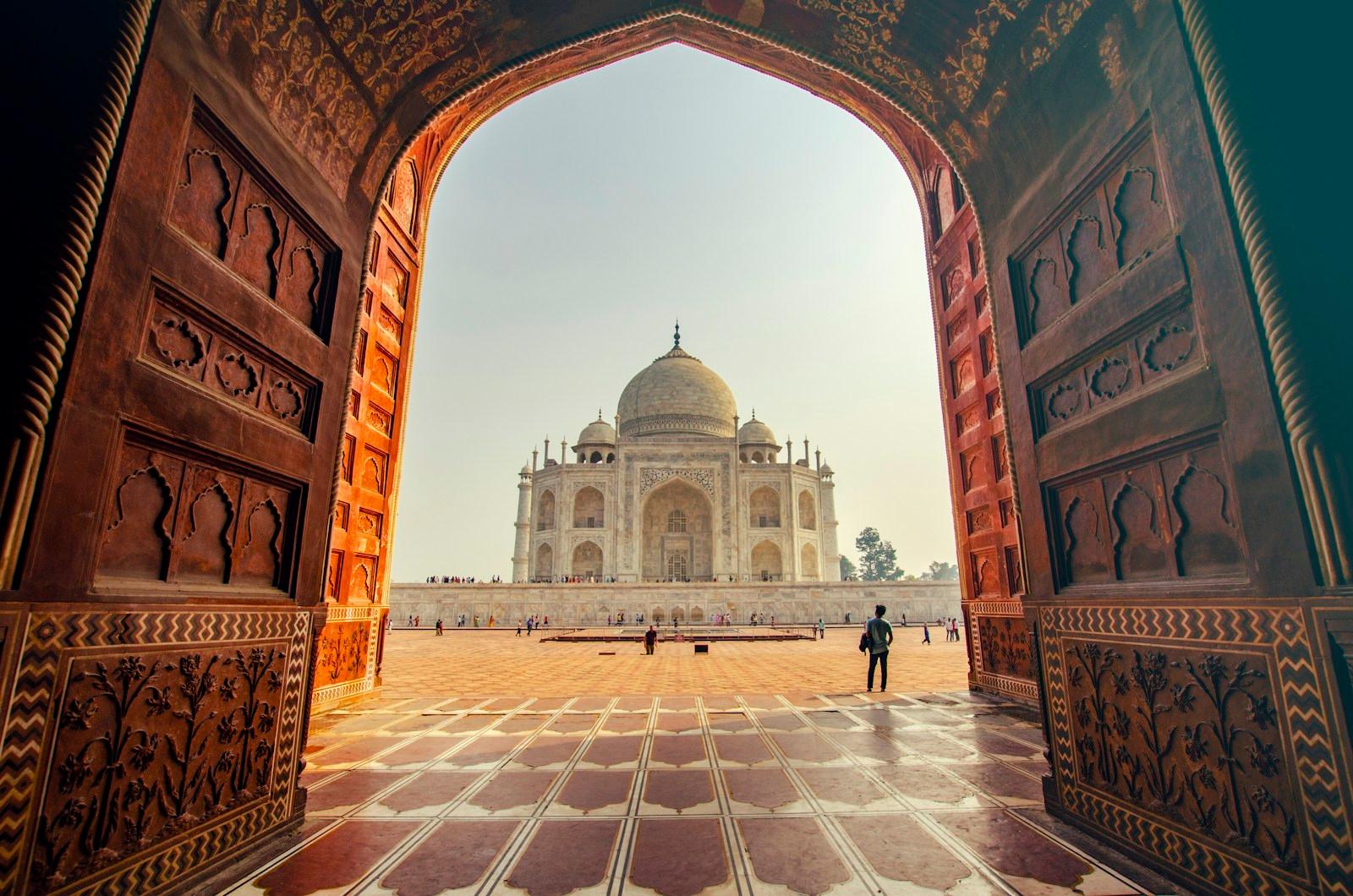 The Taj Mahal framed by a grand sandstone archway