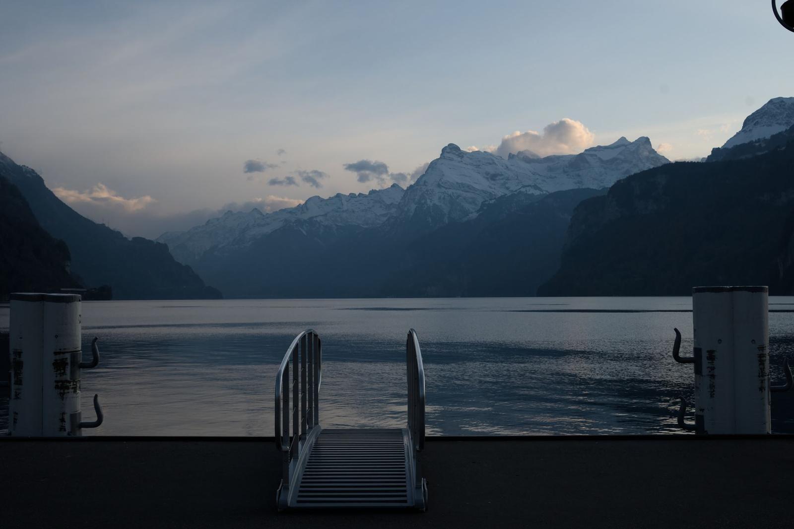 Tranquil scene of a mountain range and lake in Switzerland during dusk
