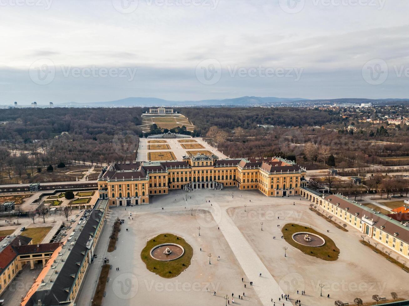 Aerial view of a symmetrical formal garden before a baroque palace