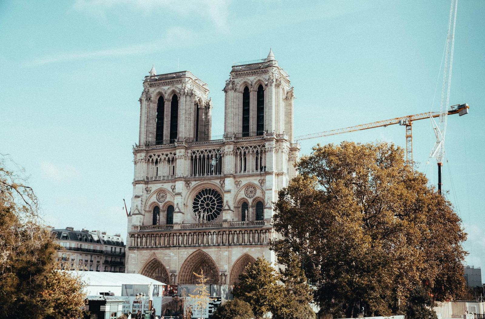 View of the iconic Notre Dame Cathedral in Paris during restoration work with cranes visible