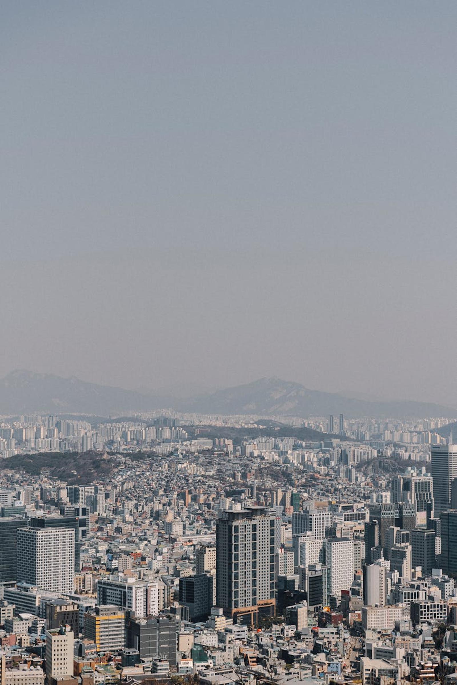 Sprawling high-rise cityscape fading into a hazy distance