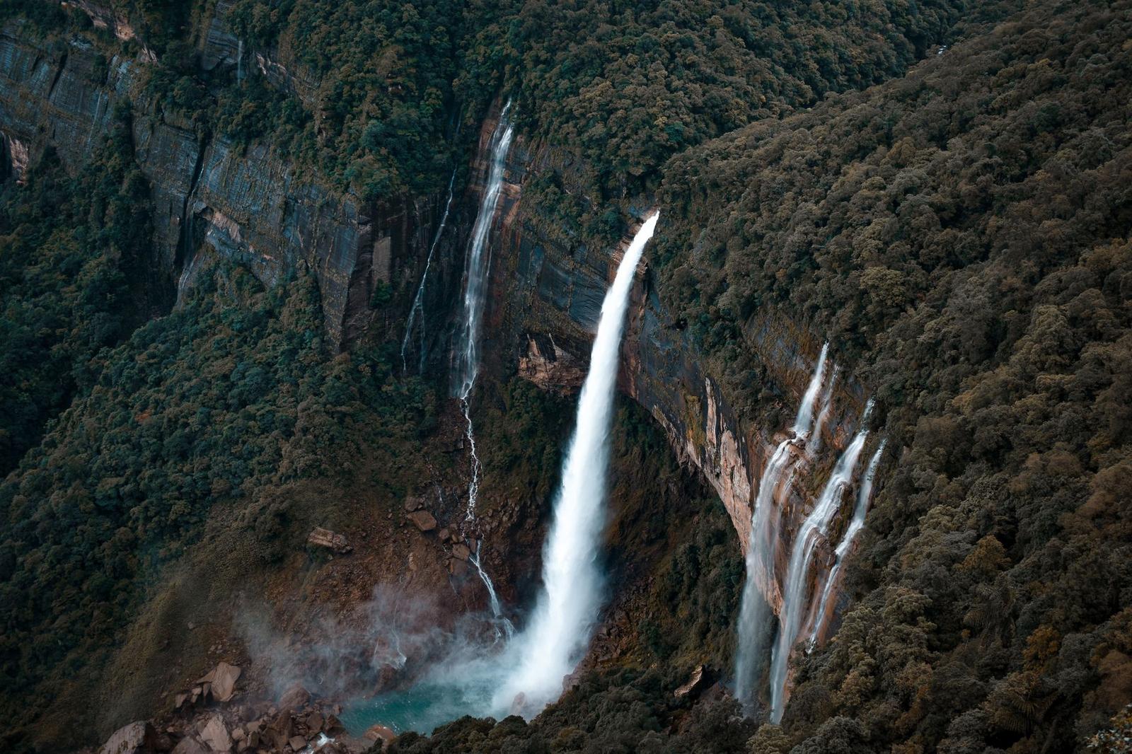 A breathtaking waterfall cascades in a lush rainforest