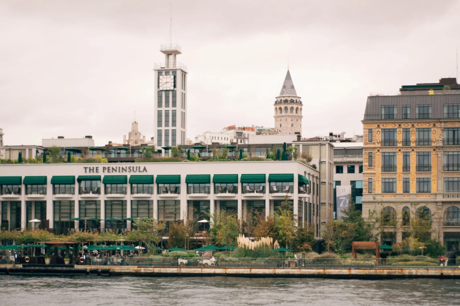 View of Galata Tower and The Peninsula Hotel from the Bosphorus in Istanbul, Turkey