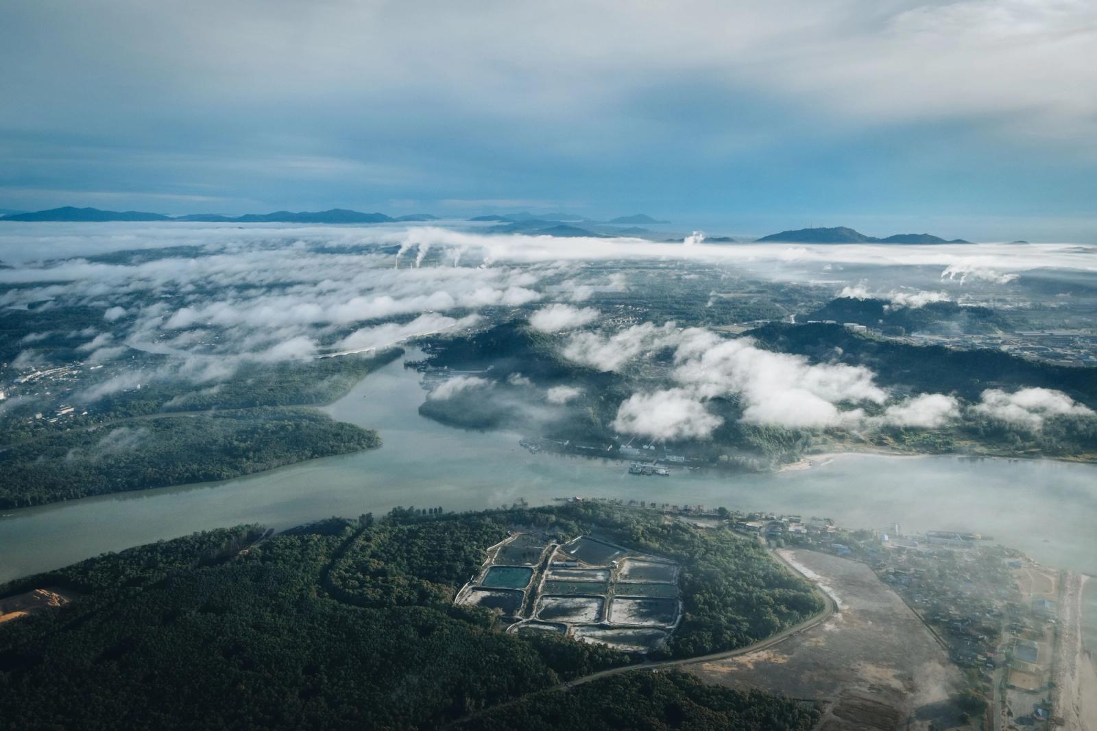 Aerial view of Chukai's scenic landscape with rivers, clouds, and lush greenery in Terengganu, Malaysia
