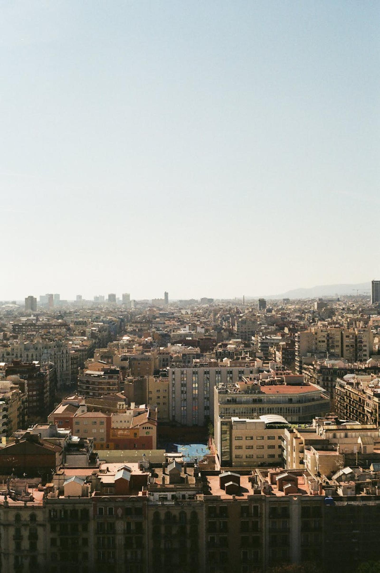 Dense urban rooftops stretching toward a hazy horizon