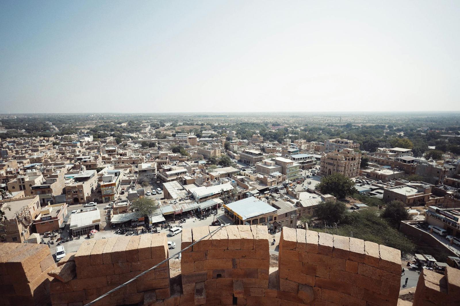 View from a fort rampart over a sprawling desert town below
