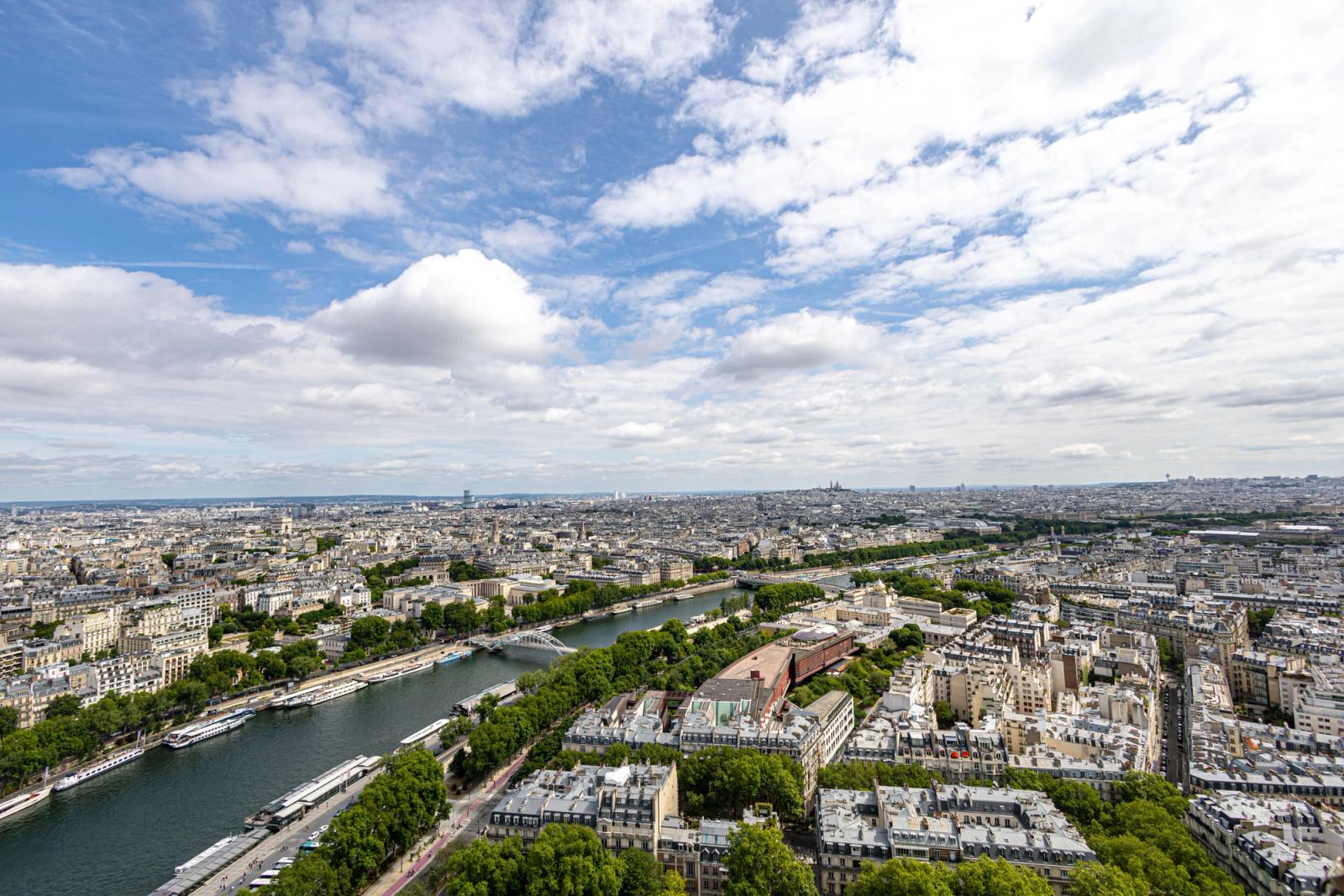 Stunning aerial view of Paris skyline with the River Seine under a bright sky