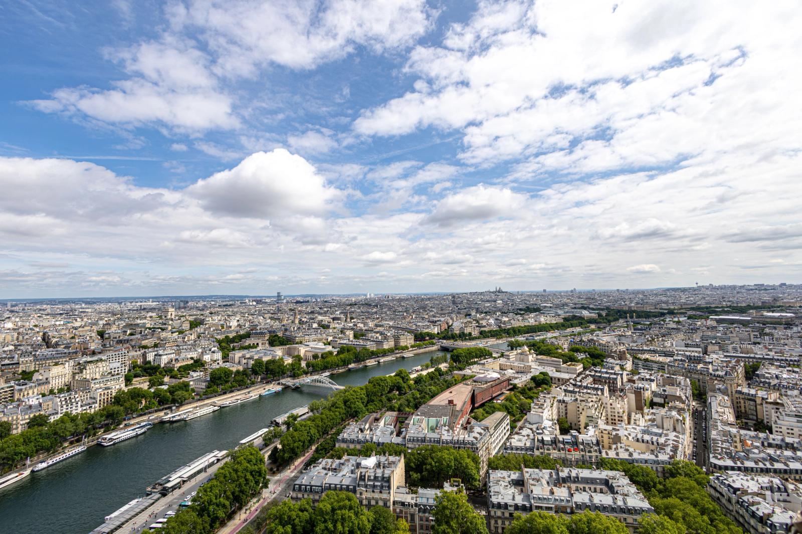 Stunning aerial view of Paris skyline with the River Seine under a bright sky