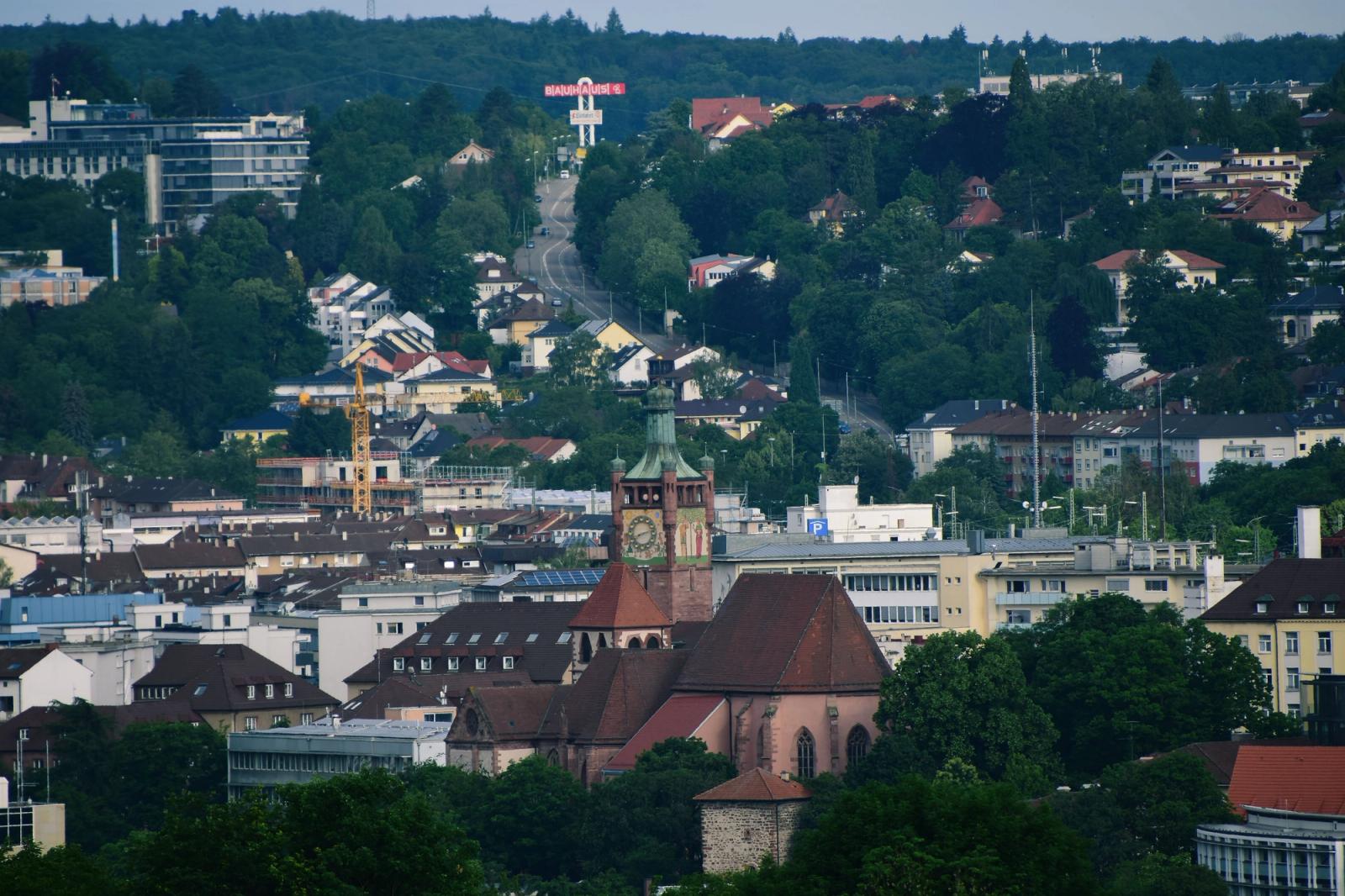 A picturesque view of Pforzheim's cityscape featuring a historic church surrounded by lush greenery