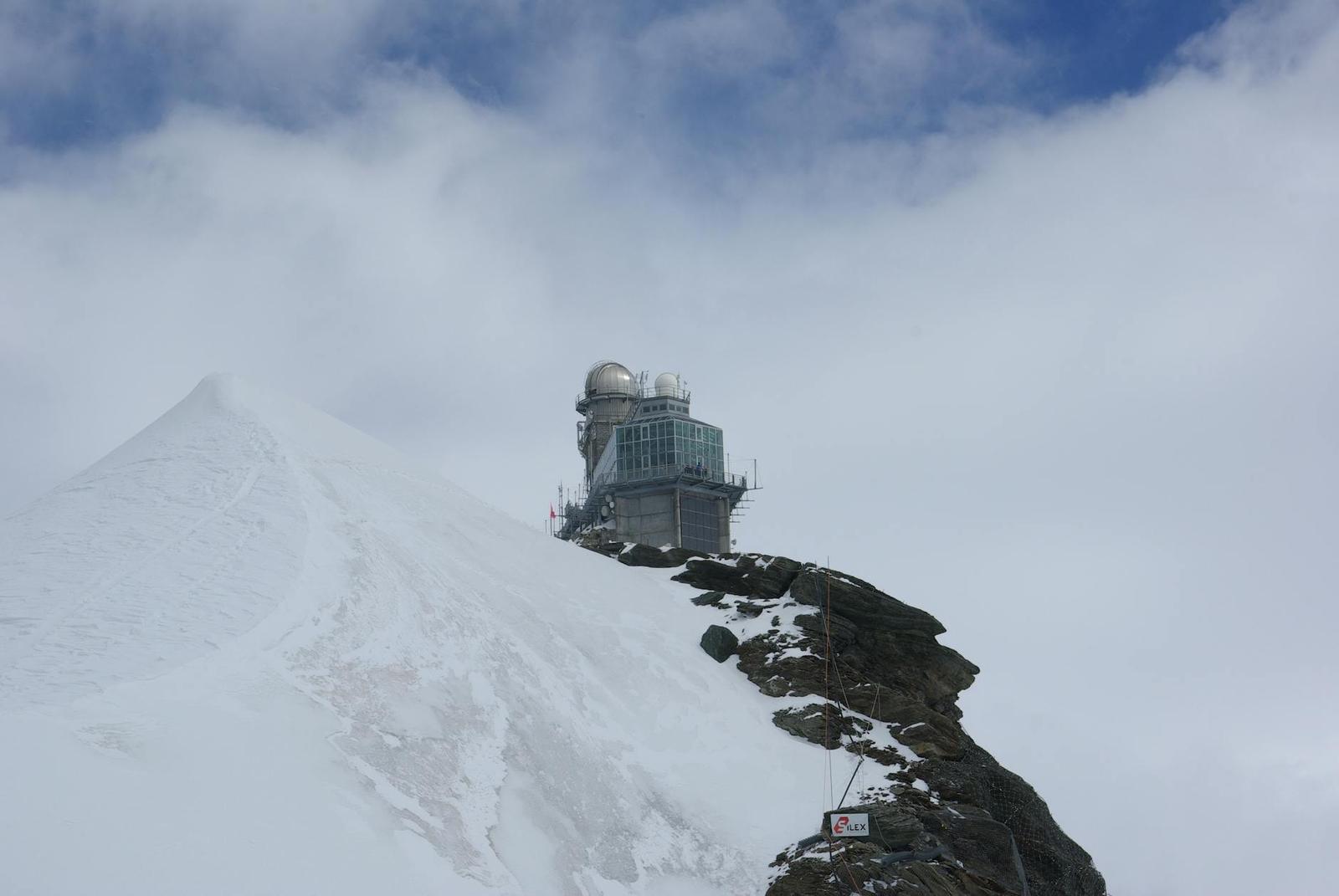 High-altitude observatory on a snow-covered mountain peak