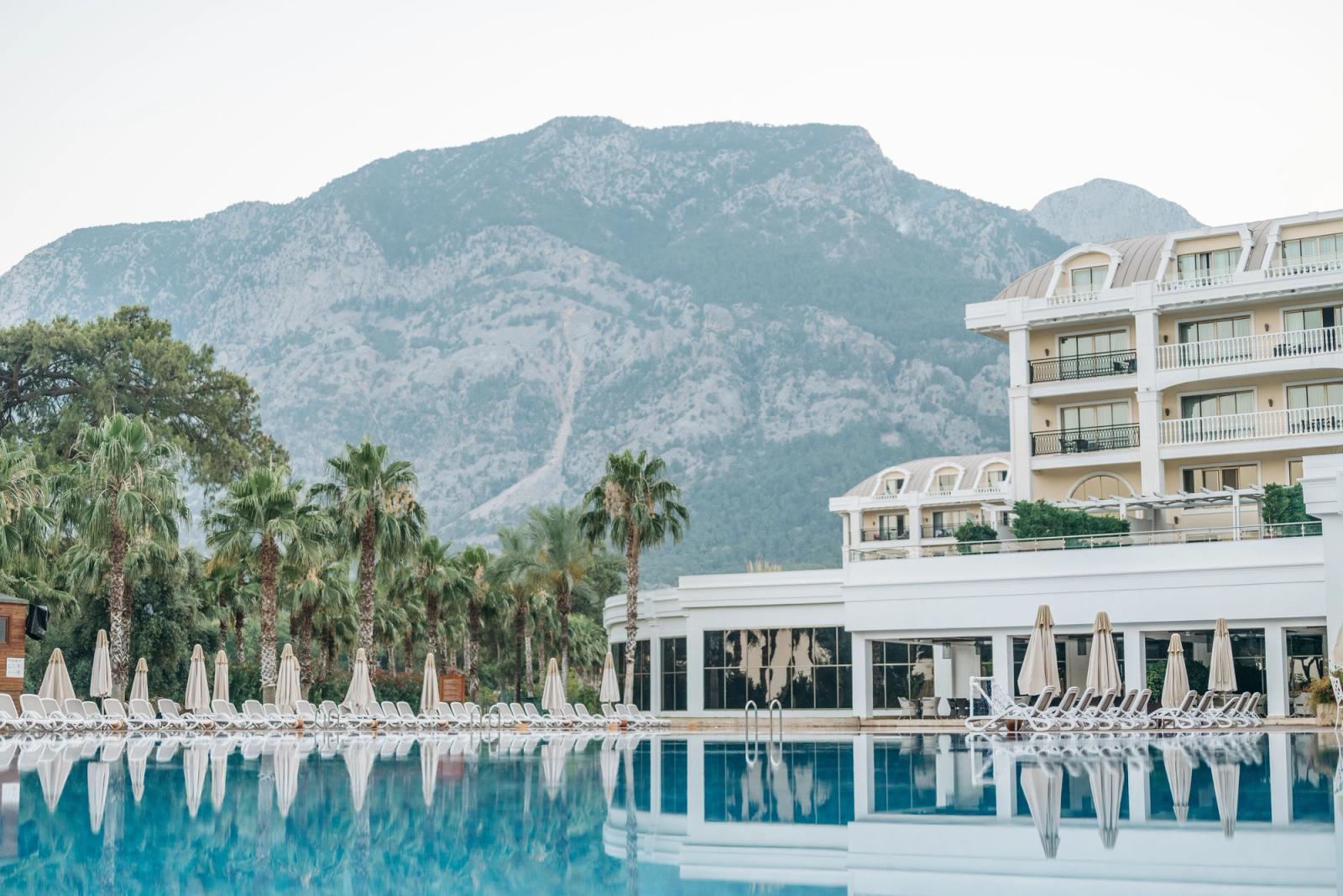Tranquil luxury hotel paradise with mountain backdrop and inviting poolside setting