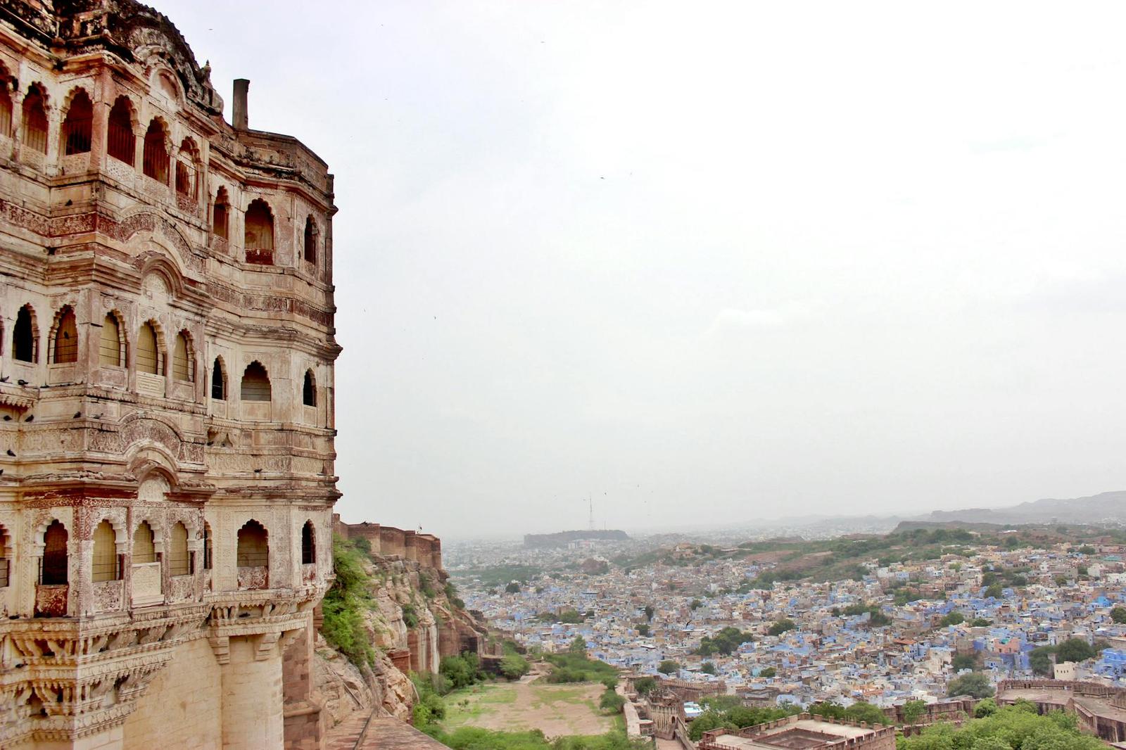 A fort balcony overlooking a sprawling blue-painted old city