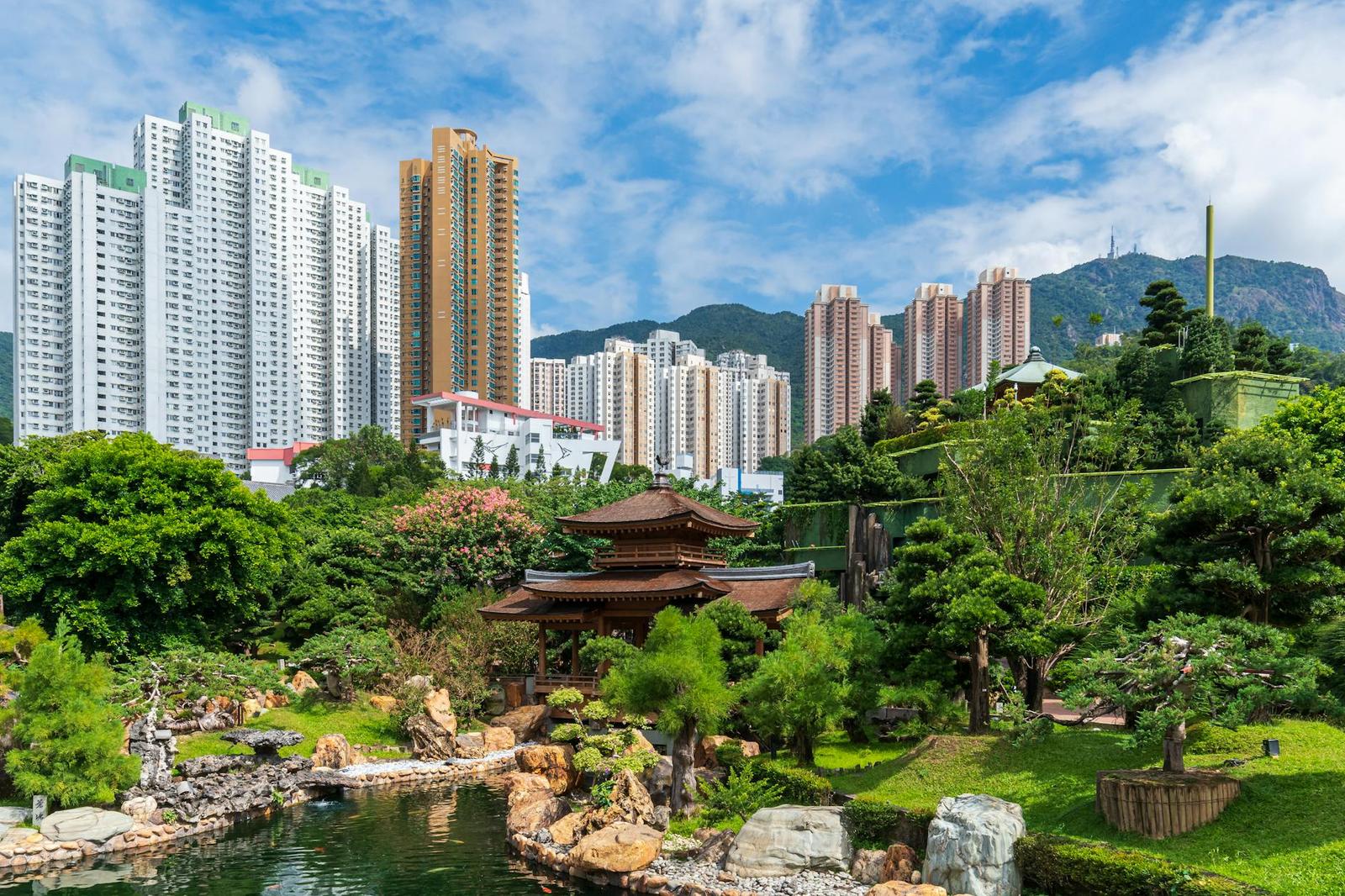 A traditional garden contrasts with modern skyscrapers in Hong Kong's vibrant cityscape