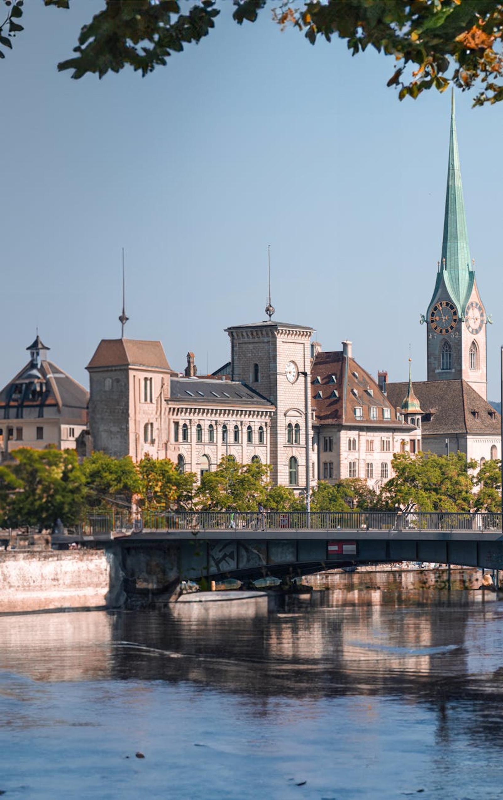 A tranquil scene capturing Zürich's historic architecture and picturesque river view