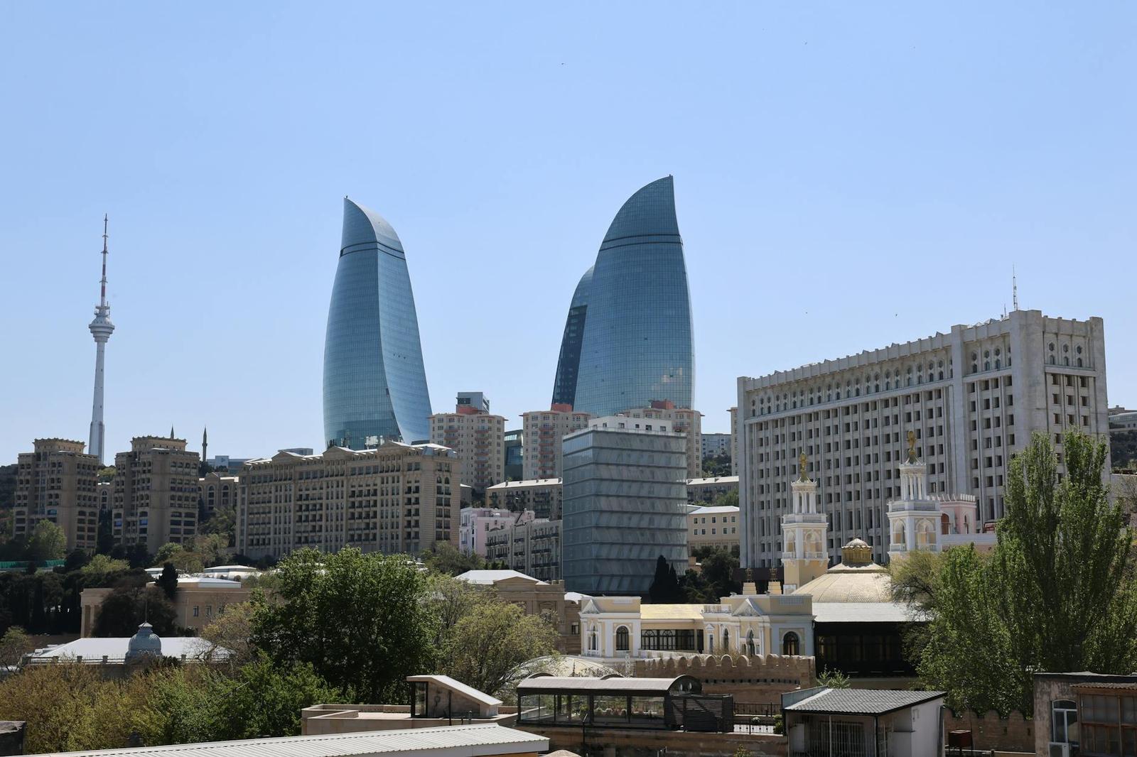 Stunning daytime cityscape of Baku with iconic Flame Towers and visible TV tower