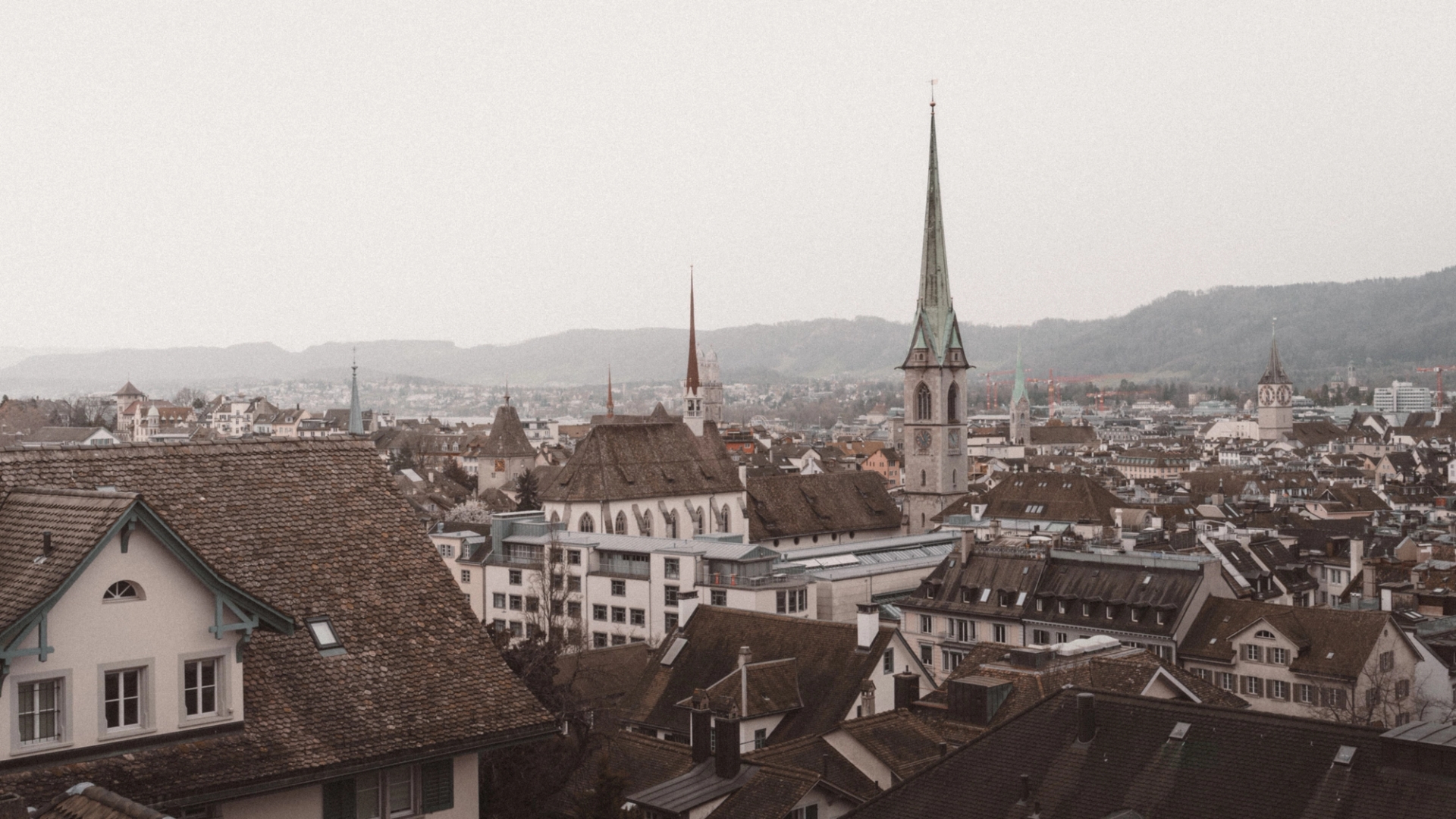 Aerial view of the picturesque old town of Zürich, highlighting historical architecture and iconic churches