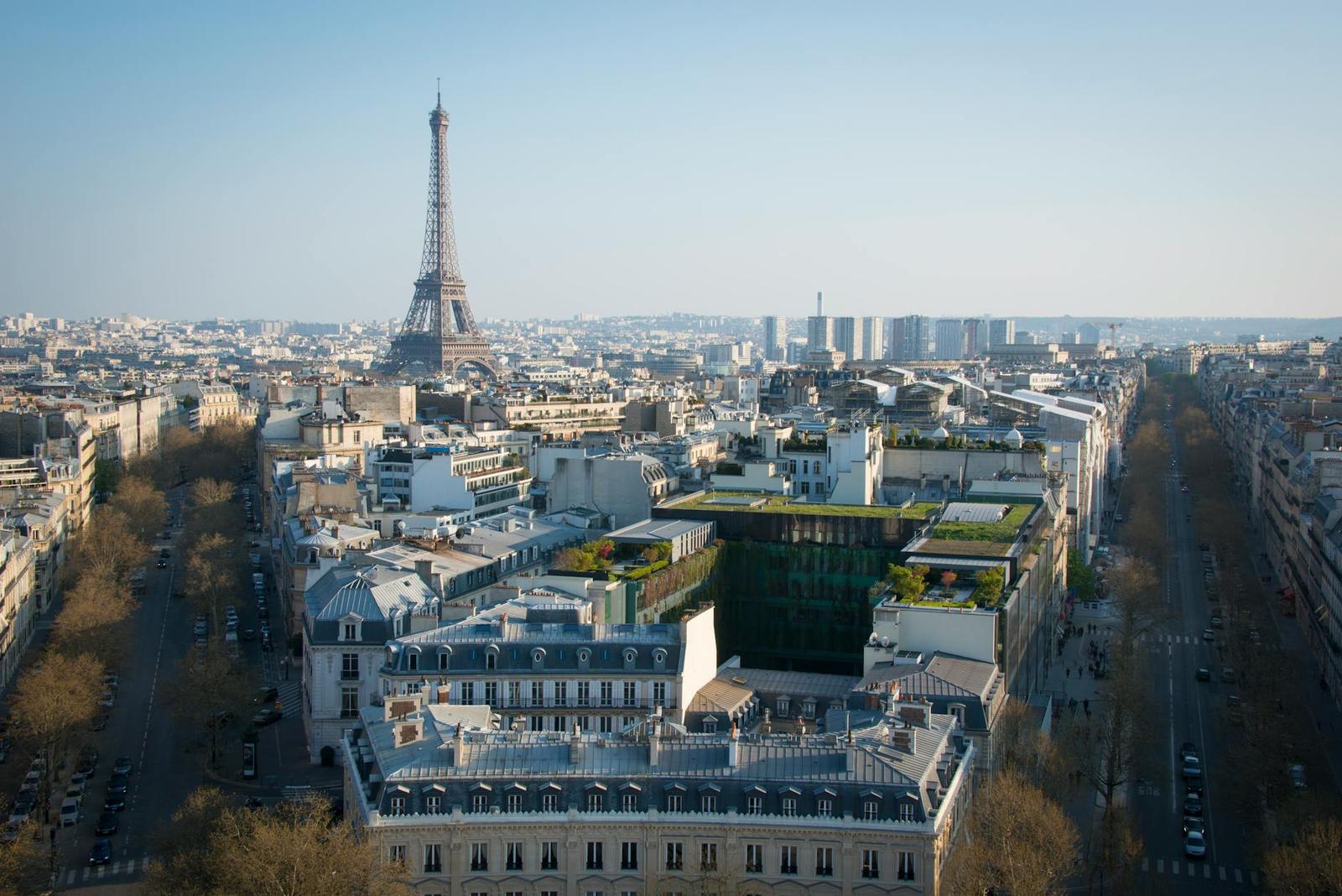 Stunning aerial view of Paris cityscape featuring the iconic Eiffel Tower under a clear blue sky