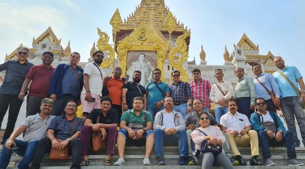 Group of people posing together fornt of the temple
