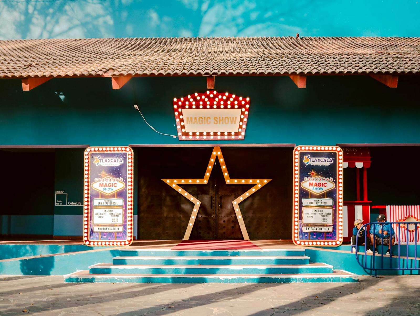Illuminated star marquee lighting a magic show entrance