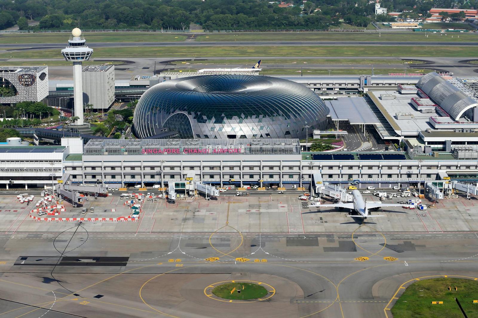 An aerial view of an airport terminal with a distinctive domed glass structure