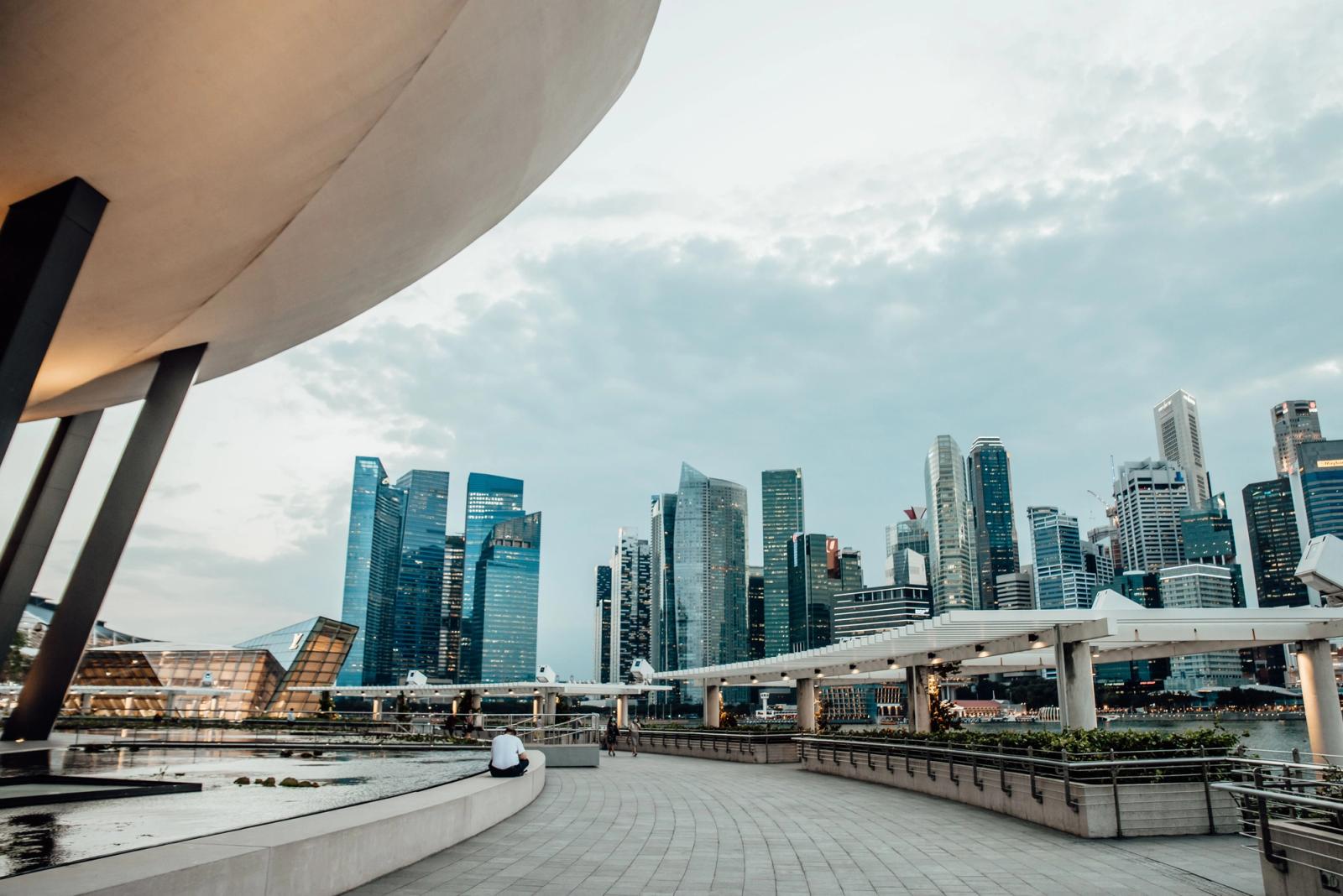 View of the iconic Singapore skyline and Marina Bay Sands from the promenade at twilight