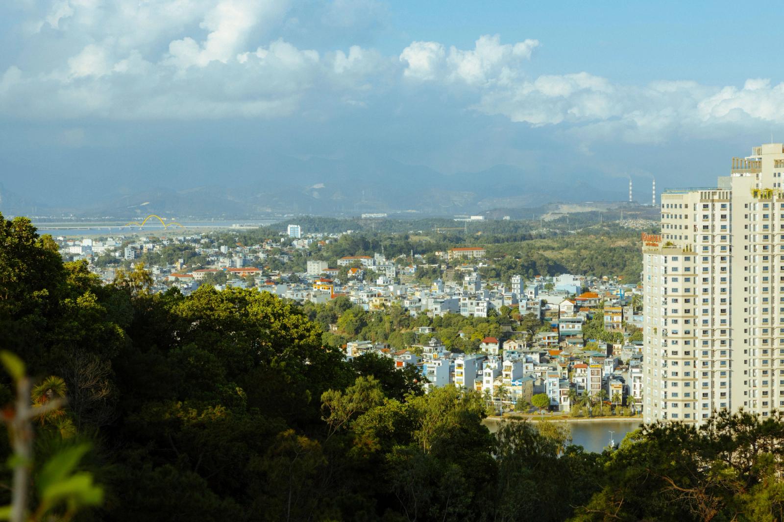Aerial view of a vibrant city in Vietnam with high-rise buildings and lush greenery