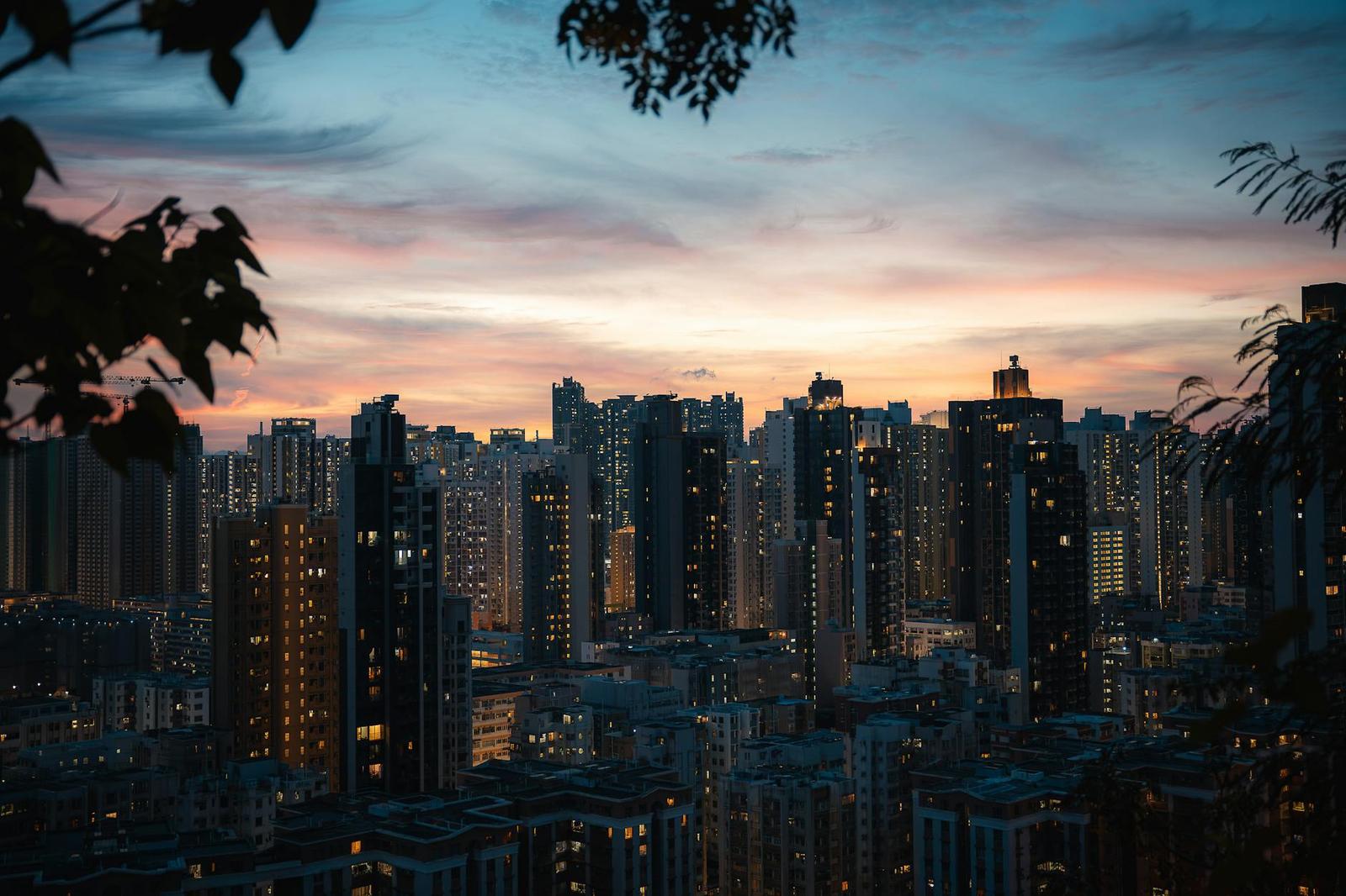 A dense high-rise skyline lit up at dusk