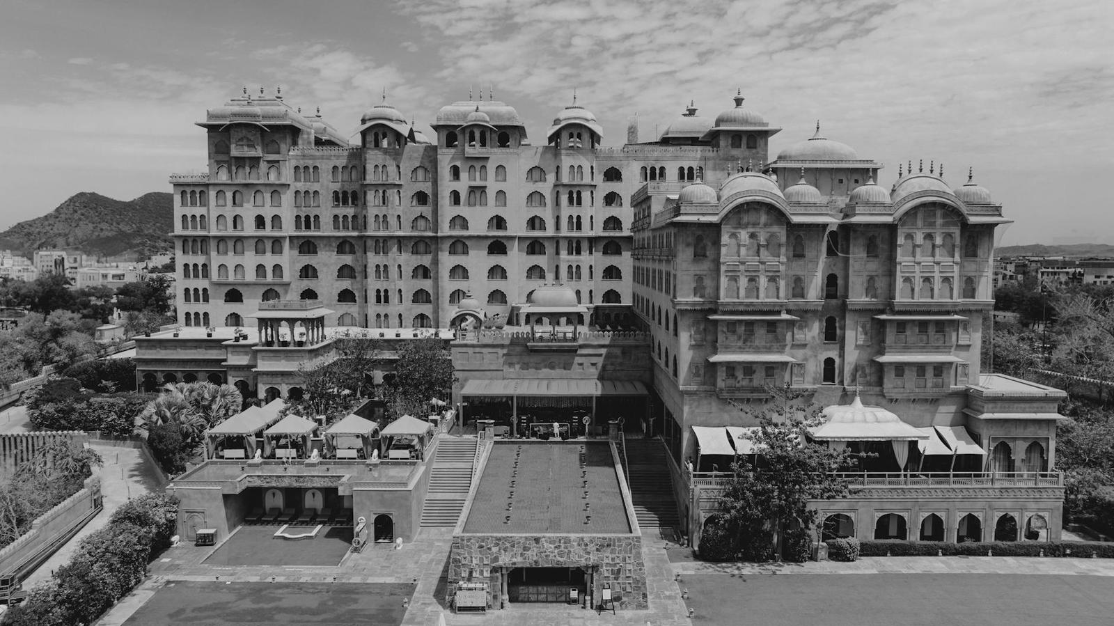 Aerial black and white view of a grand palace hotel with domed towers and courtyards