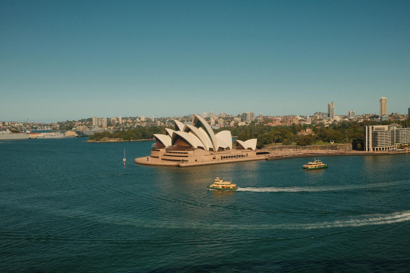 Aerial view of Sydney Opera House with ferries in Sydney Harbour, Australia