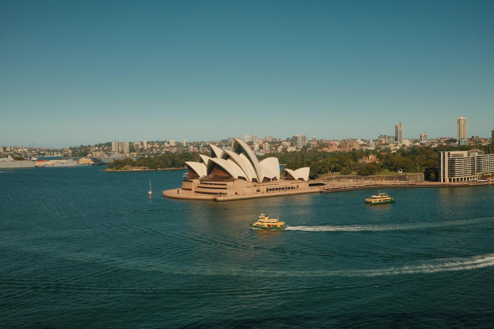 Aerial view of Sydney Opera House with ferries in Sydney Harbour, Australia