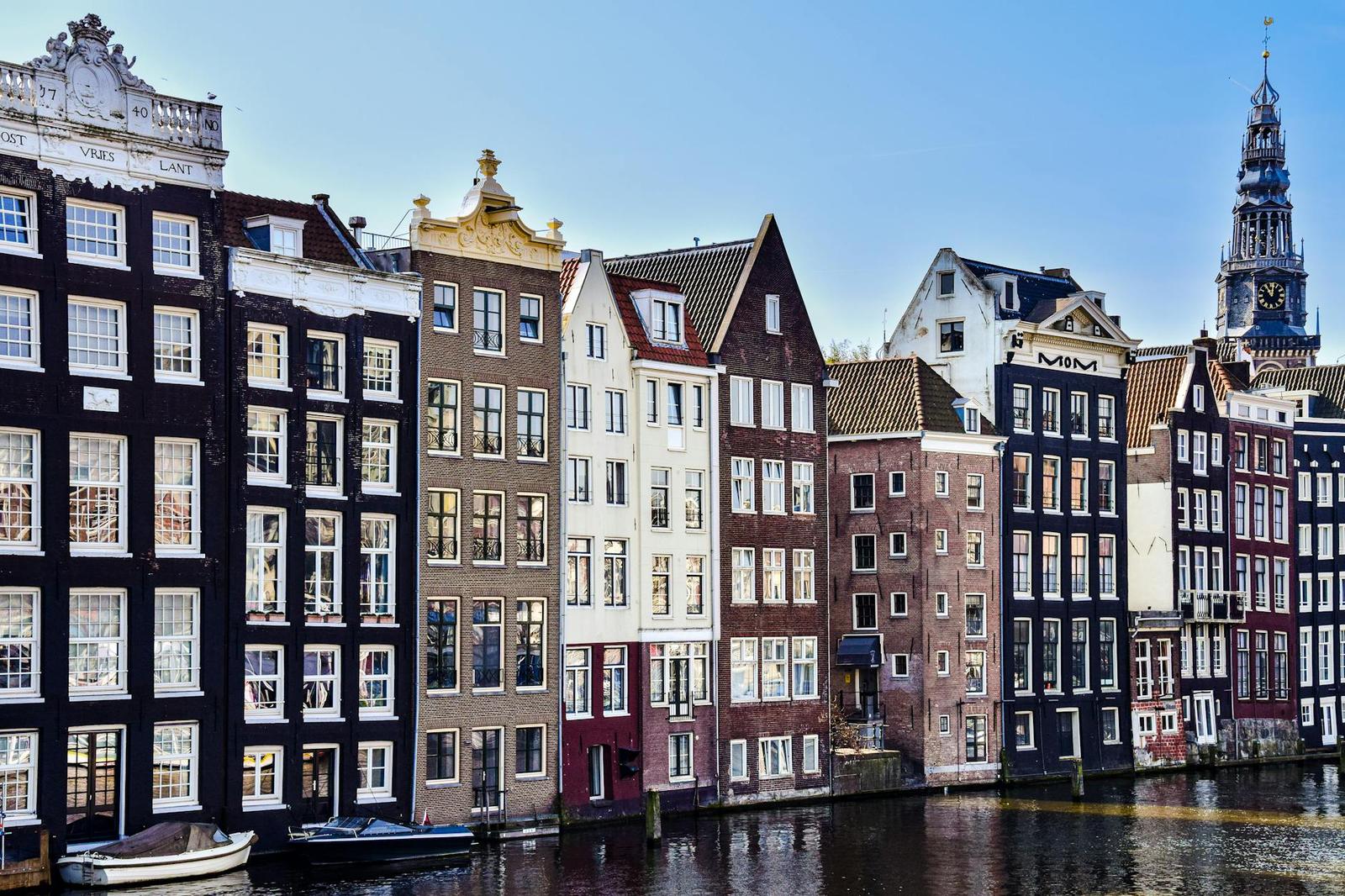 View of Amsterdam's iconic canal lined with historic tall buildings