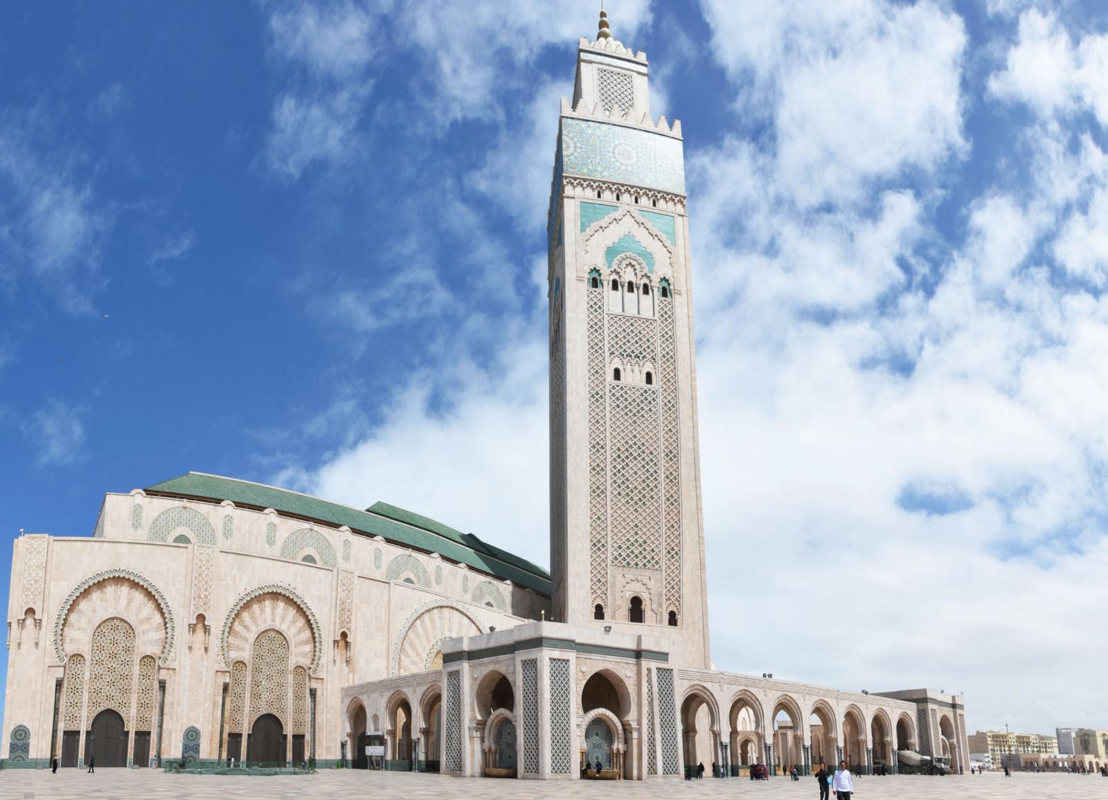 Beautiful low angle view of Hassan II Mosque in Casablanca showcasing its iconic minaret under a blue sky