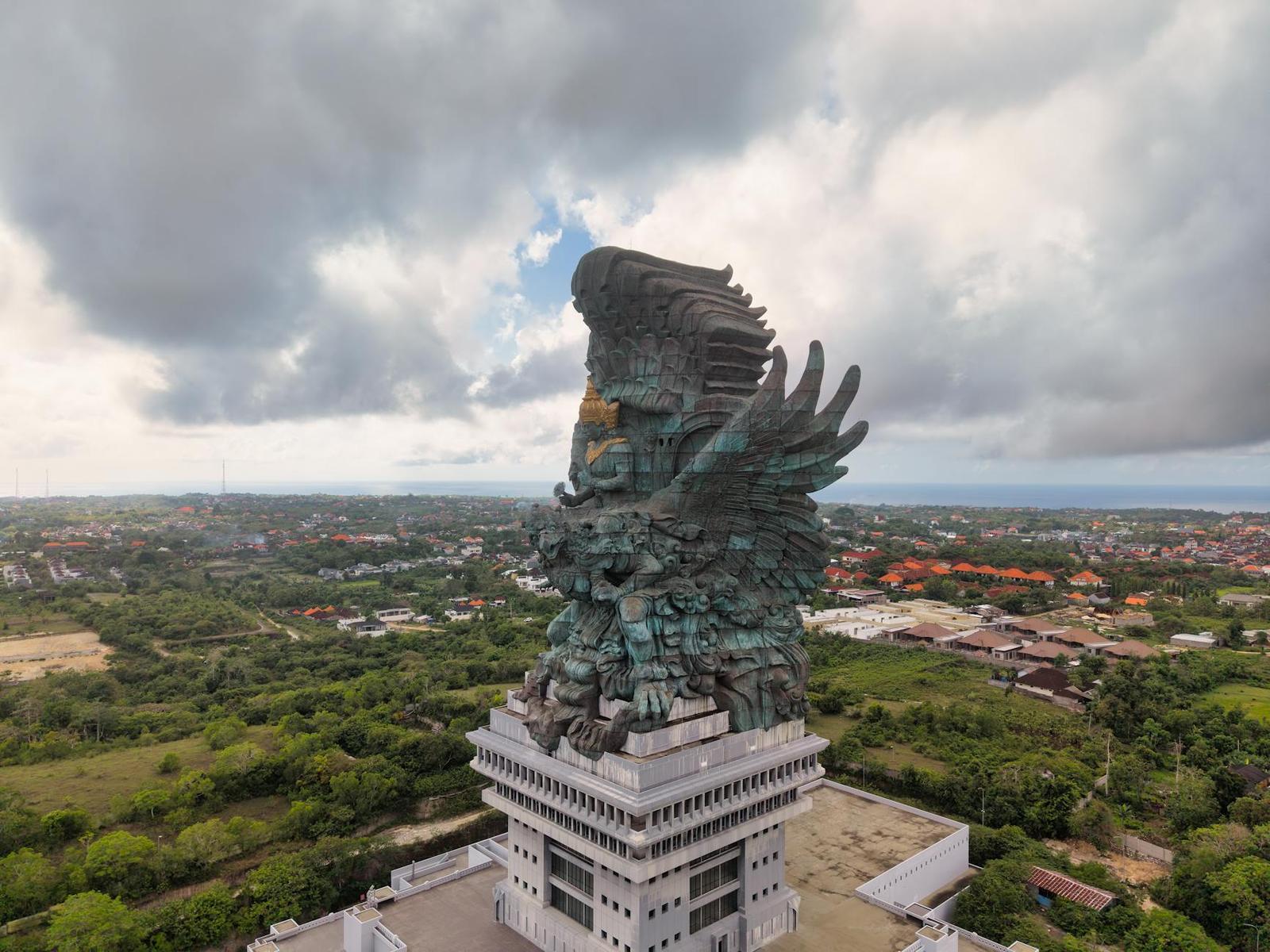 Stunning aerial shot of Garuda Wisnu Kencana statue surrounded by lush greenery in Bali, Indonesia