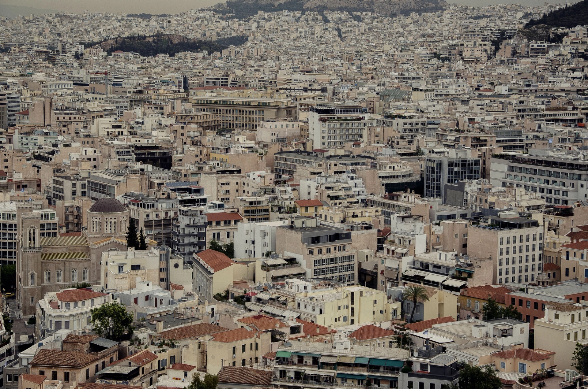 Dense urban cityscape of Athens with traditional architecture and rooftops